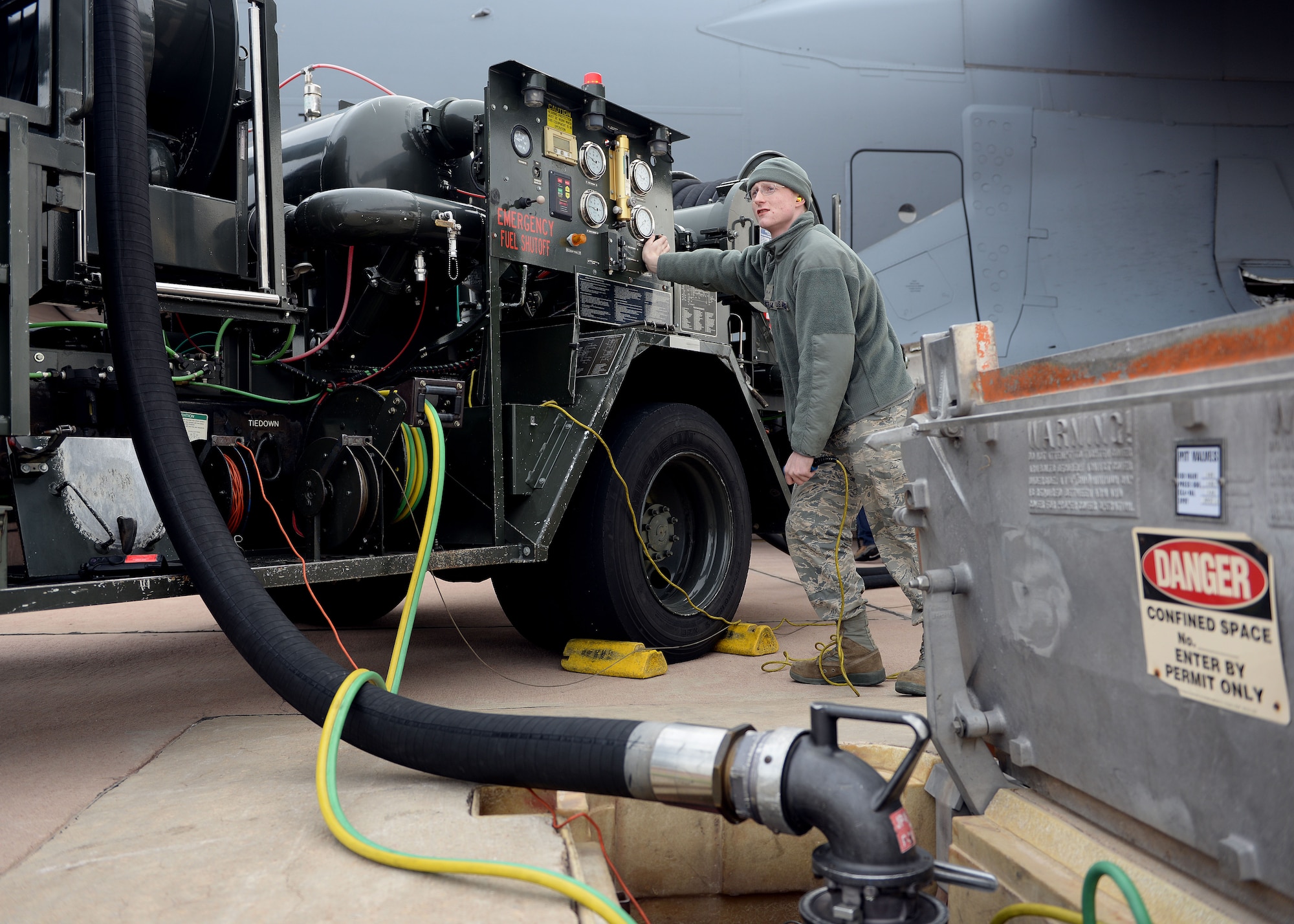 ALTUS AIR FORCE BASE, Okla. – U.S. Airman 1st Class Austin Cantelmi, 97th Logistics Readiness Squadron fuels operator, manually drains a tank while servicing fuel to a U.S. Air Force C-17 Globemaster III cargo aircraft, Jan. 29, 2015. It is vitally important that fuel is handled correctly to prevent fuel spills, aircraft crashes, and even potential cryogenic burns or explosions. (U.S. Air Force photo by Airman 1st Class Megan E. Acs/Released)
