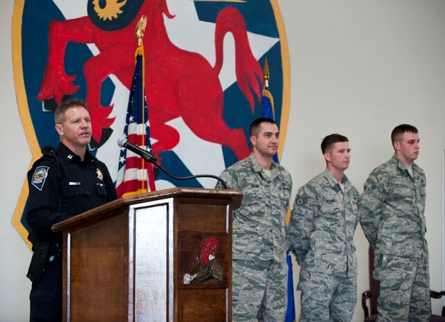 Capt. Thom Jackson (left), Nevada Highway Patrol state trooper, speaks to the 820th RED HORSE at Nellis Air Force Base, Nev., Jan. 23, 2015. Jackson attended the ceremony to honor the bravery shown by, Tech Sgt. Adam Dixon, Staff Sgt. James Maxwell and Airman 1st Class Christopher Fitzgerald during a flash flood rescue on Aug. 4, 2014. The three Nellis AFB Airmen, who were assisted by three members of the 799th Air Base Squadron from Creech AFB, took quick, live-saving reactions to rescue an elderly couple trapped in their car during the flash flood on U.S. Route 95 north of Las Vegas. The Airmen were able to save the couple before the car was swept away by the water. For their actions, Dixon, Maxwell and Fitzgerald received commendation medals from the Nevada Highway Patrol. (U.S. Air Force photo by Senior Airman Thomas Spangler)