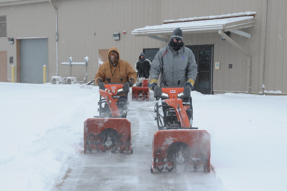 Gentlemen, start your engines!  Niagara Falls Air Reserve Station contracted Snow removal laborers for Satellite Services Inc.  form a line with their snow blowers to remove snow from all sidewalks and building doorways at the base on January 30, 2015. Despite the recent snowfall, workers commented that 2015 has not been a bad year for snow removal, so far. (U.S. Air Force photo by Peter Borys)
