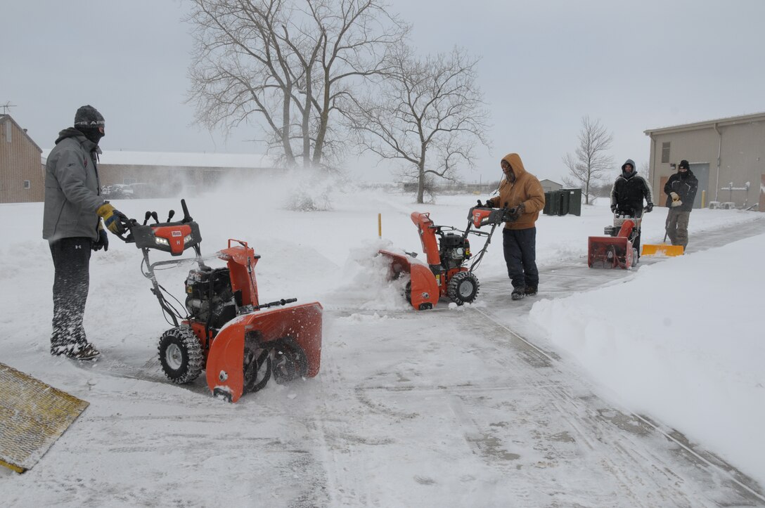 Niagara Falls Air Reserve Station contracted Snow removal laborers for Satellite Services Inc.  remove snow from all sidewalks and building doorways at the base on January 30, 2015. Despite the recent snowfall, workers commented that 2015 has not been a bad year for snow removal, so far. (U.S. Air Force photo by Peter Borys)
