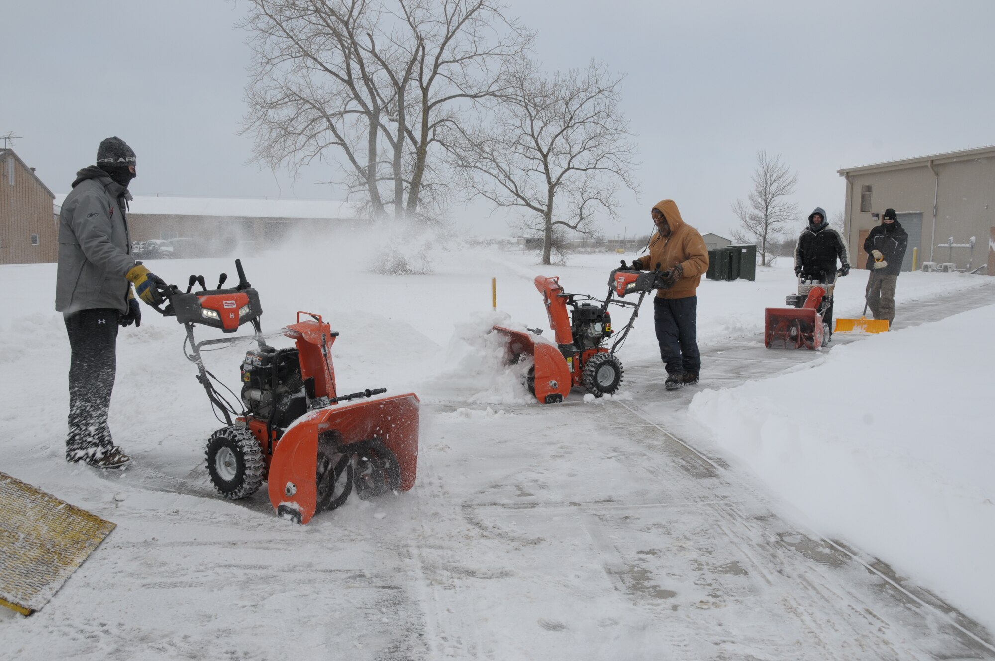 Niagara Falls Air Reserve Station contracted Snow removal laborers for Satellite Services Inc.  remove snow from all sidewalks and building doorways at the base on January 30, 2015. Despite the recent snowfall, workers commented that 2015 has not been a bad year for snow removal, so far. (U.S. Air Force photo by Peter Borys)