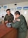 U.S. Air Force 2nd Lt. Tristan Stonger, a C-130 pilot for the Kentucky Air Guard's 165th Airlift Squadron, talks with a Polish Air Force official at Powidz Air Base, Poland, Dec. 10, 2014, during a three-week deployment in support of Operation Atlantic Resolve. The Kentucky Air Guard fielded two C-130 aircraft and 50 personnel to conduct joint training and focus on interoperability in support of NATO operations. (Courtesy Photo)