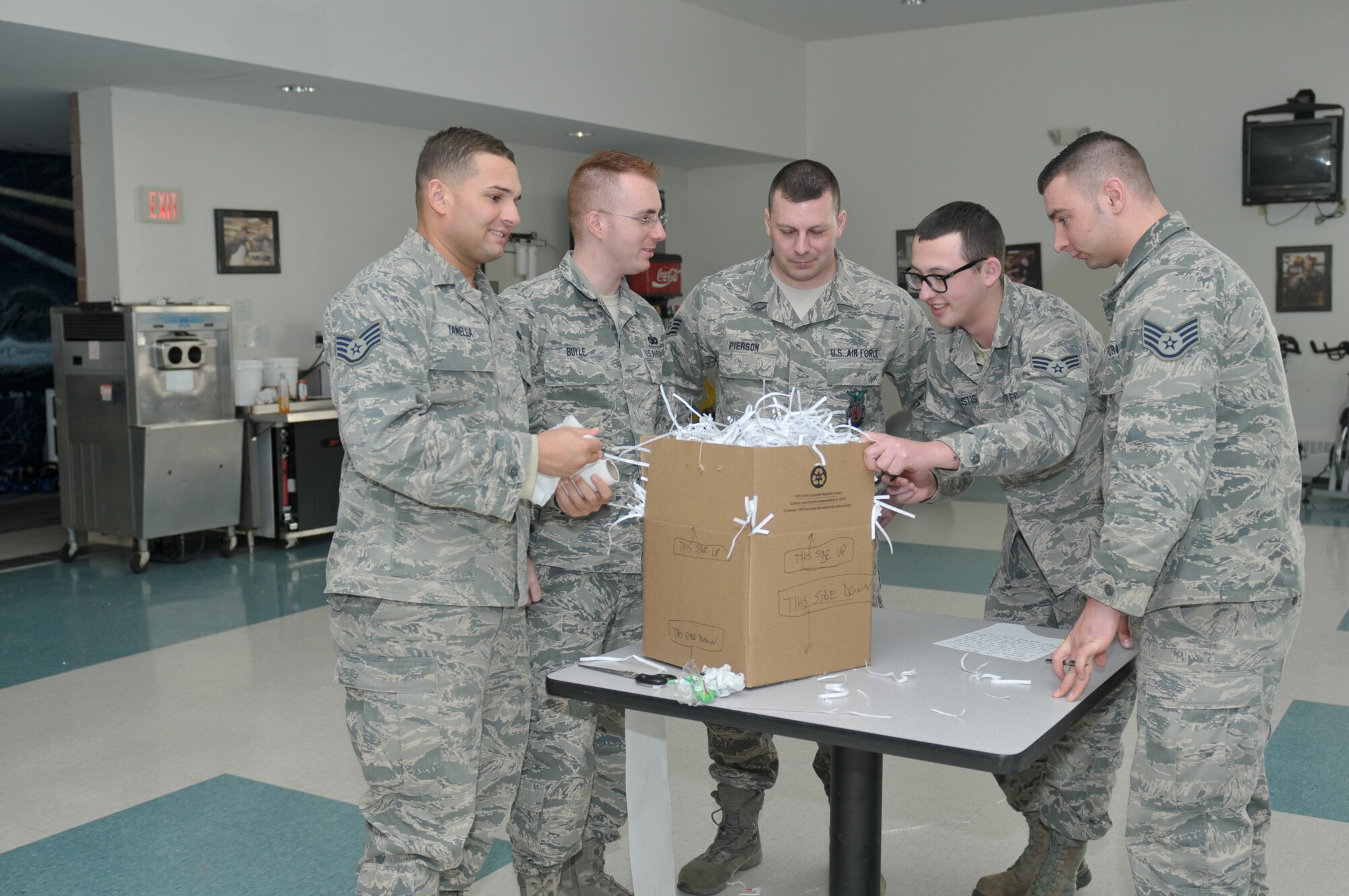 Airmen build a "chicken coop" as part of a teambuilding exercise during the 109th Airlift Wing's first Airman Development Course at Stratton Air National Guard Base, N.Y., on  Jan. 29, 2015. 14 Airmen throughout the base took the three-day course Jan. 28-30, 2015. Along with teambuilding, the course covered topics on public speaking, Air Force heritage, 109th AW history, conflict resolution, the evaluation process, financial and educational benefits, and more. (U.S. Air National Guard photo by Master Sgt. William Gizara/Released)