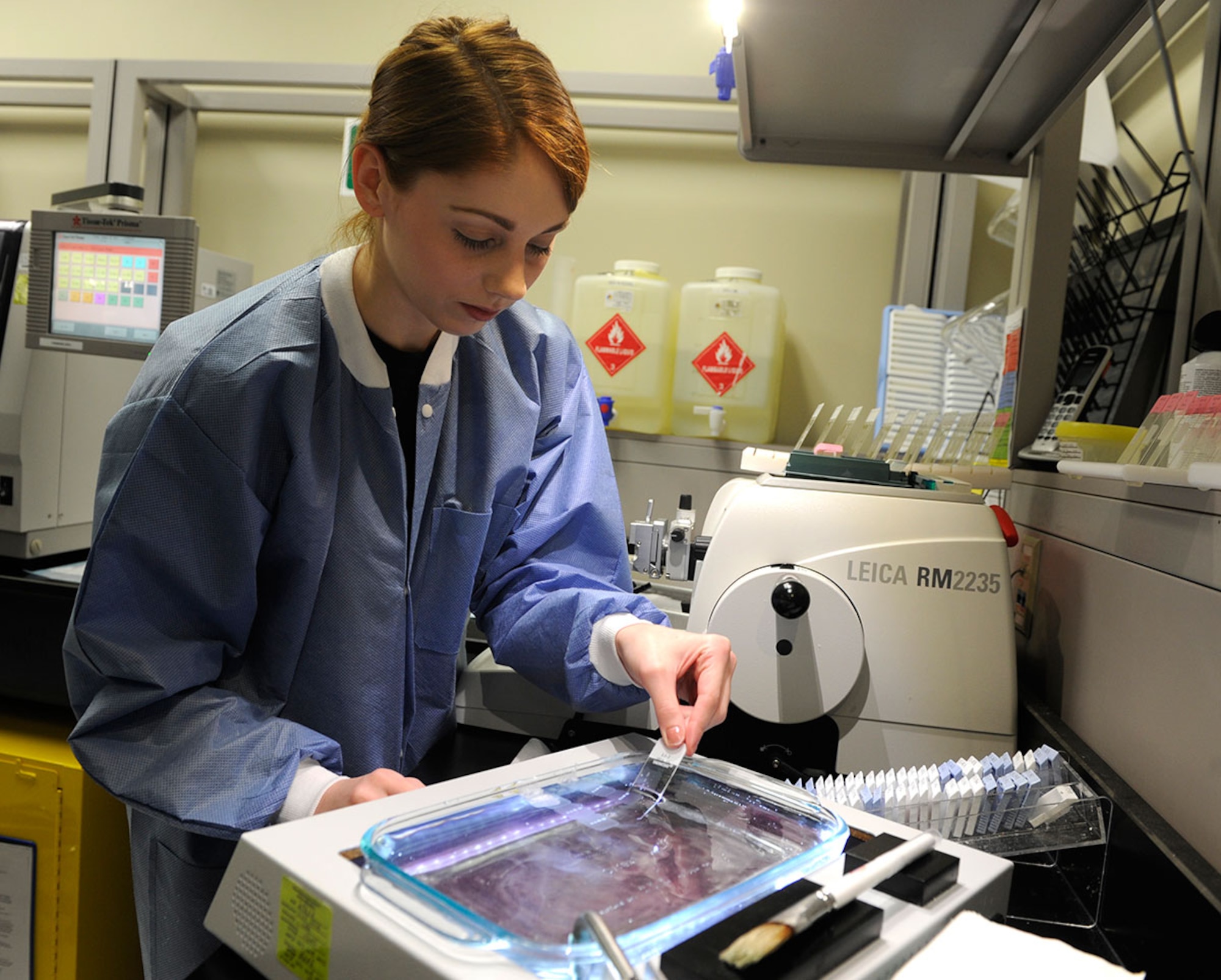 Senior Airman Taylor Davis, 673d Medical Support Squadron histology technician, applies tissue to a slide after cutting it on a microtome in a laboratory here Jan. 19. Histopathology is just one part of the Air Force’s Biomedical Sciences Corps, a discipline composed of 17 primary specialty codes. This year, the BSC turns 50 years old. (U.S. Air Force photo/Staff Sgt. Wes Wright)