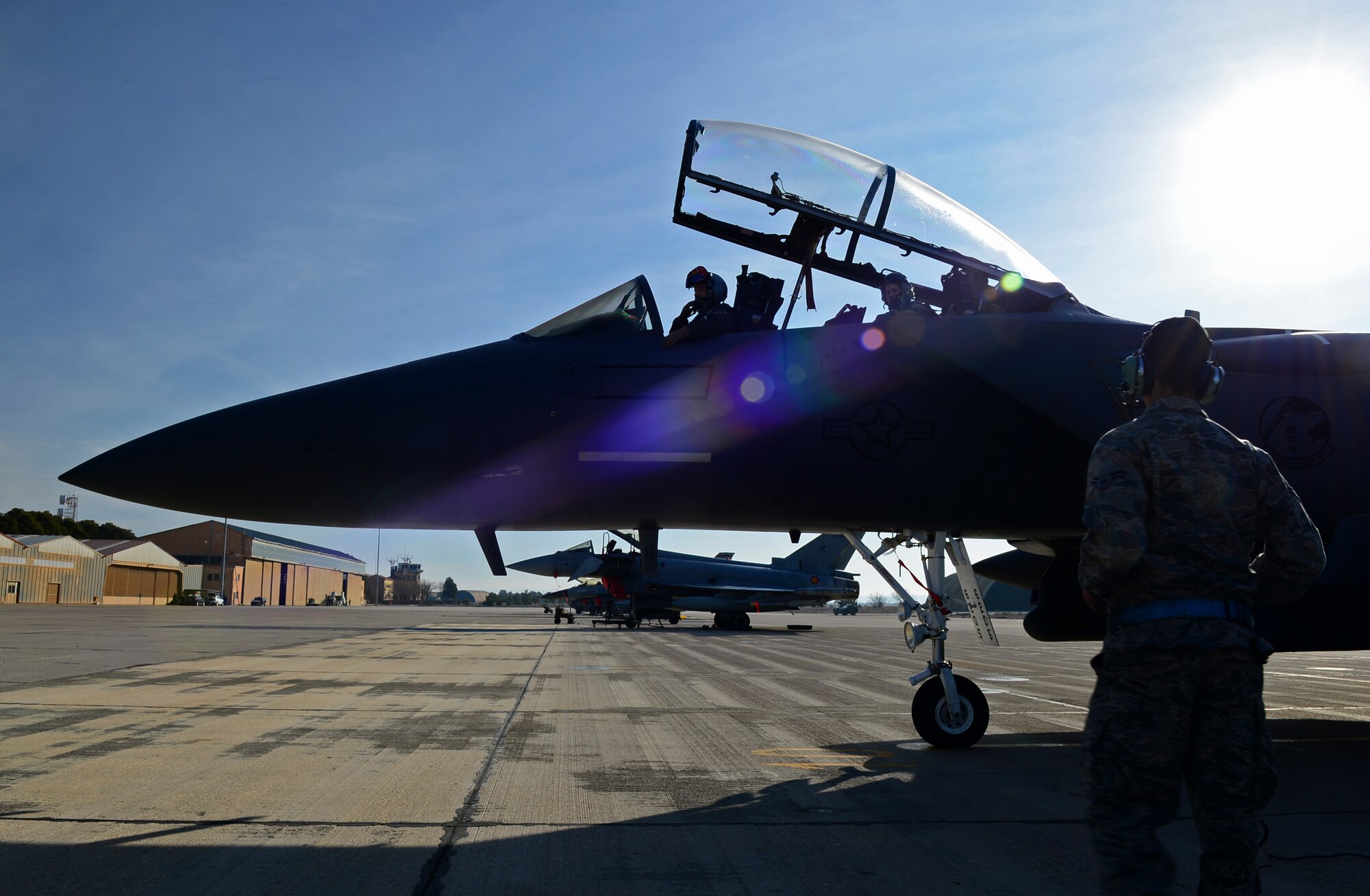 Airman 1st Class Oscar Mares, 492nd Aircraft Maintenance Unit crew chief, waits for the aircrew to start the engine of an F-15E Strike Eagle at Los Llanos Air Base, Spain, Jan. 29, 2015. The 492nd Fighter Squadron was in Spain to participate in the 2015 Tactical Leadership Programme, which was cut short due to an aircraft crash on Jan. 26, 2015. (U.S. Air Force photo by Airman 1st Class Erin R. Babis/Released)