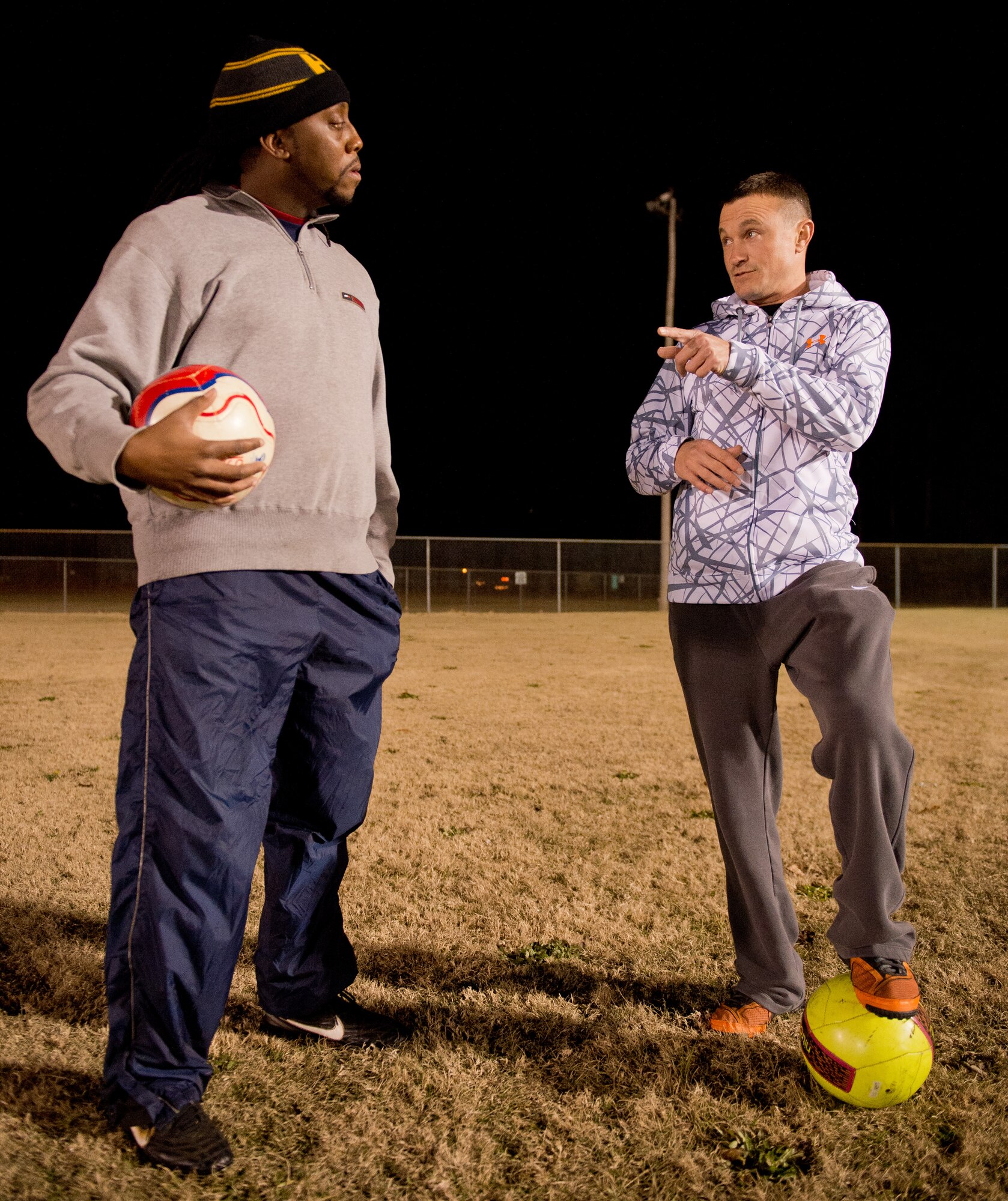 U.S. Air Force Master Sgt. Jason Butts, right, a ground explosives safety craftsman with the 116th Air Control Wing, Georgia Air National Guard, speaks to co-coach, Chris Harris, about game strategy during a practice held in Warner Robins, Ga., Dec. 9, 2014. Butts topped thousands of fellow coaches from 12 states to take the honor as the Region 3 Boys Recreational Soccer Coach of the Year for a team he coaches in Warner Robins, Georgia.  He also won the top spot as coach of the year for the state of Georgia, and his team has won three-consecutive state championships. Butts has served as a soccer coach in his community during his off-duty hours for the past seven years. (U.S. Air National Guard photo by Master Sgt. Roger Parsons/Released)