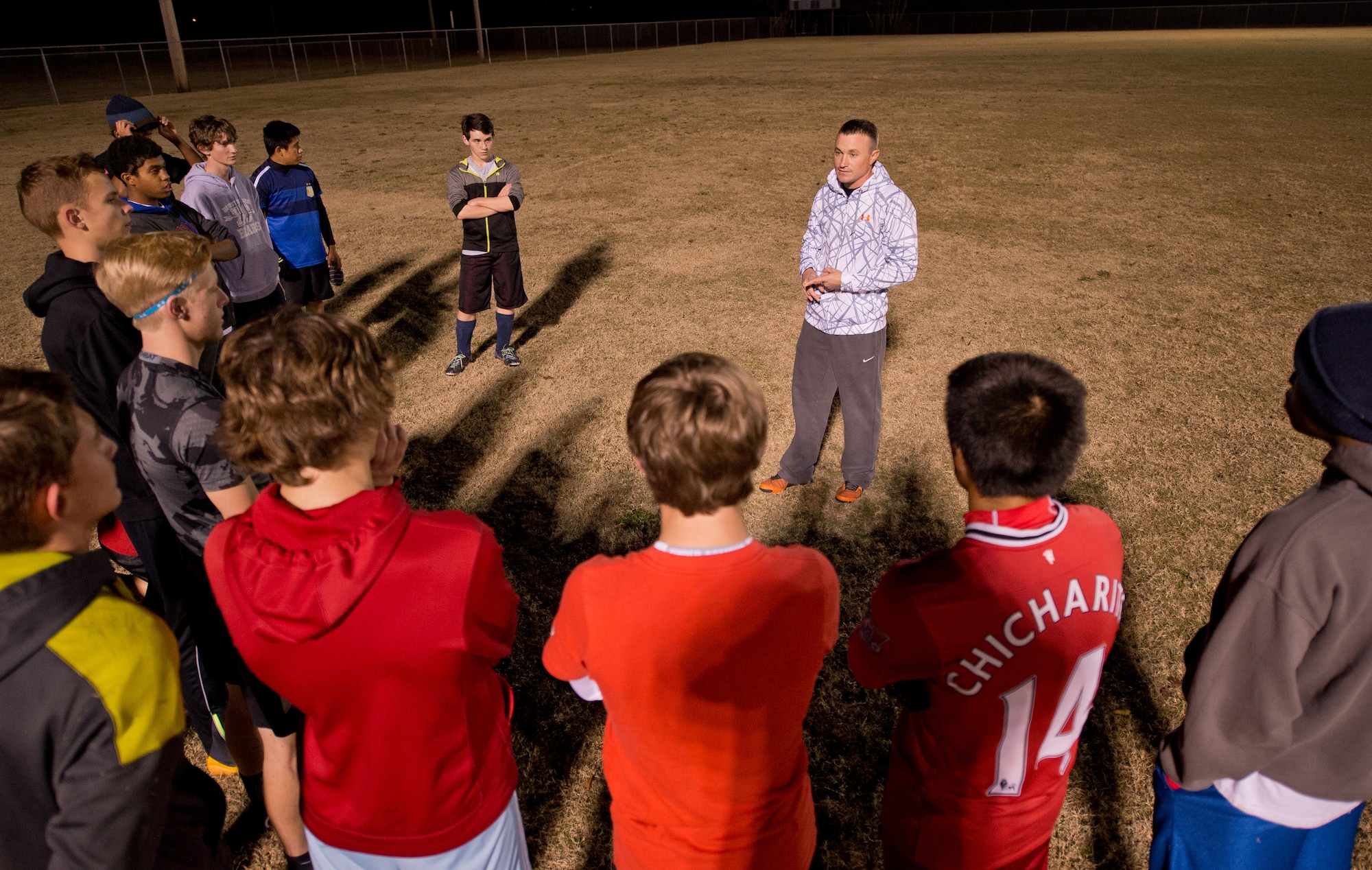 U.S. Air Force Master Sgt. Jason Butts, a ground explosives safety craftsman with the 116th Air Control Wing, Georgia Air National Guard, discusses game strategies with his team during a practice held in Warner Robins, Ga., Dec. 9, 2014. Butts topped thousands of fellow coaches from 12 states to take the honor as the Region 3 Boys Recreational Soccer Coach of the Year for a team he coaches in Warner Robins, Georgia.  He also won the top spot as coach of the year for the state of Georgia, and his team has won three-consecutive state championships. Butts has served as a soccer coach in his community during his off-duty hours for the past seven years. (U.S. Air National Guard photo by Master Sgt. Roger Parsons/Released)