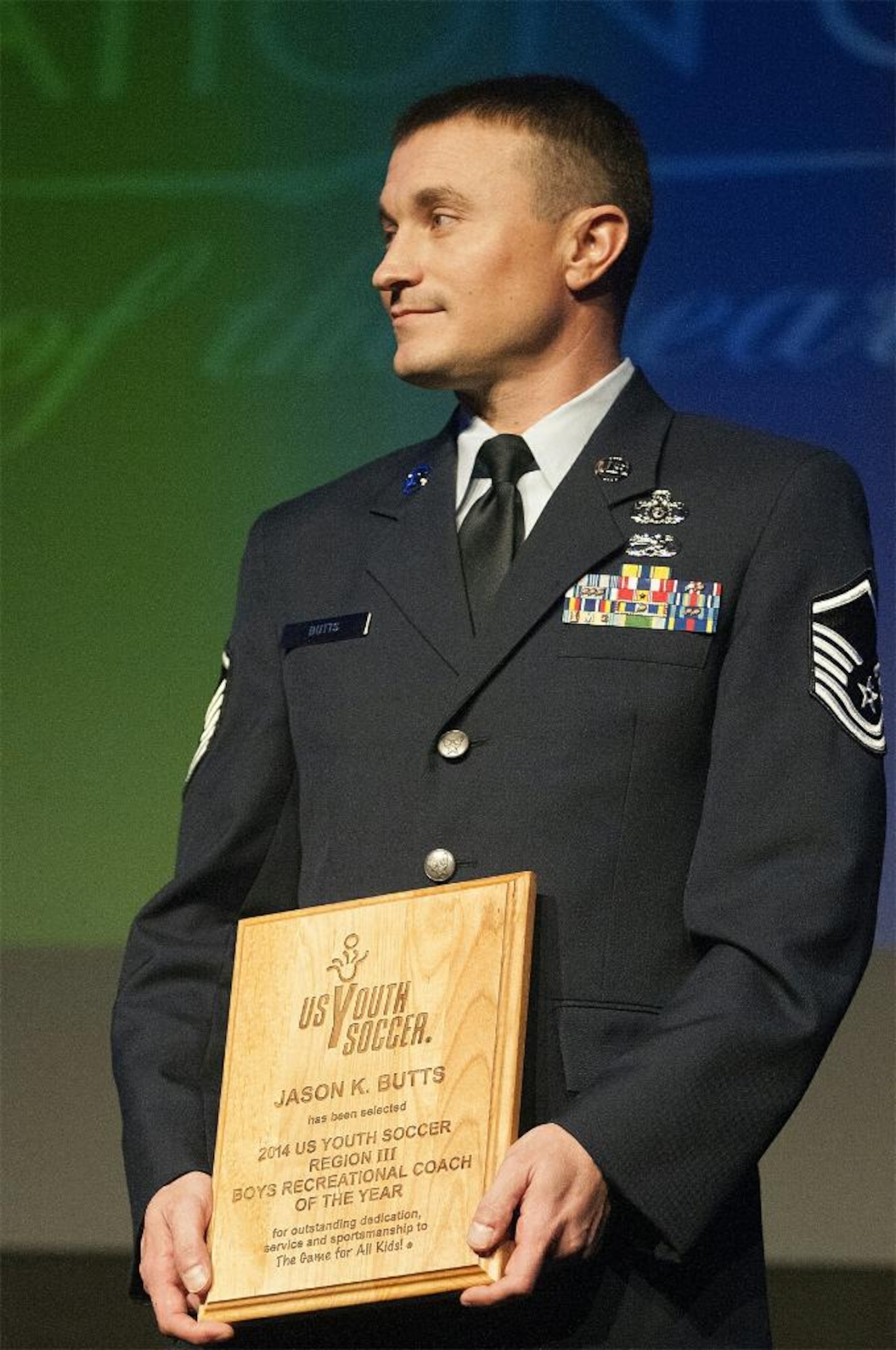U.S. Air Force Master Sgt. Jason Butts, a ground explosives safety craftsman with the 116th Air Control Wing, Georgia Air National Guard, holds the plaque he was presented at the 2014 U.S. Youth Soccer Awards Gala, Philadelphia, Pa., Jan. 17, 2015. Butts topped thousands of fellow coaches from 12 states to take the honor as the Region 3 Boys Recreational Soccer Coach of the Year for a team he coaches in Warner Robins, Georgia.  He also won the top spot as coach of the year for the state of Georgia, and his team has won three-consecutive state championships. Butts has served as a soccer coach in his community during his off-duty hours for the past seven years. (Courtesy photo/Released)