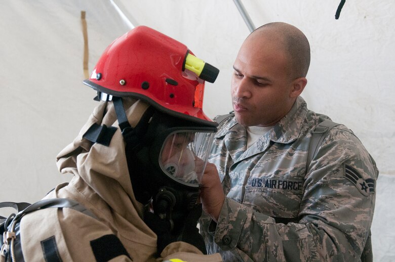 Air Force Senior Airmen Jordan Newby, a member of the Kentucky National Guard CERFP’s Fatality Search and Recovery Team, checks the suit of another team member preparing to head into the hot zone during Operation Starke Thunder at Camp Blanding in Starke, Fla., Jan. 13, 2015. The four-day exercise certified the joint Kentucky Army and Air Guard emergency-response group as mission-ready. (U.S. Air National Guard photo by Staff Sgt. Vicky Spesard)