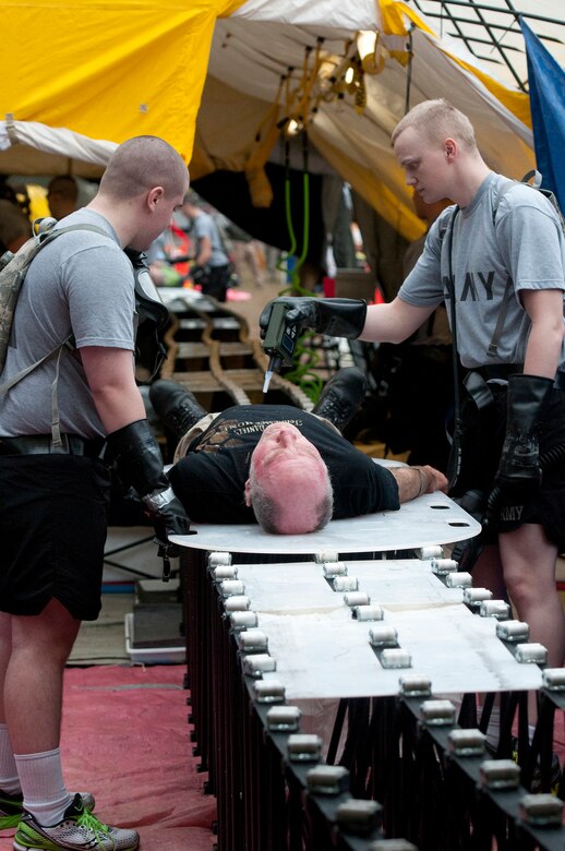 Soldiers from the Kentucky National Guard CERFP move a simulated patient from the hot zone into the cold zone for further triage as part of Operation Starke Thunder at Camp Blanding in Starke, Fla., Jan. 13, 2015. The patients were local volunteers who assisted with the exercise. (U.S. Air National Guard photo by Staff Sgt. Vicky Spesard)