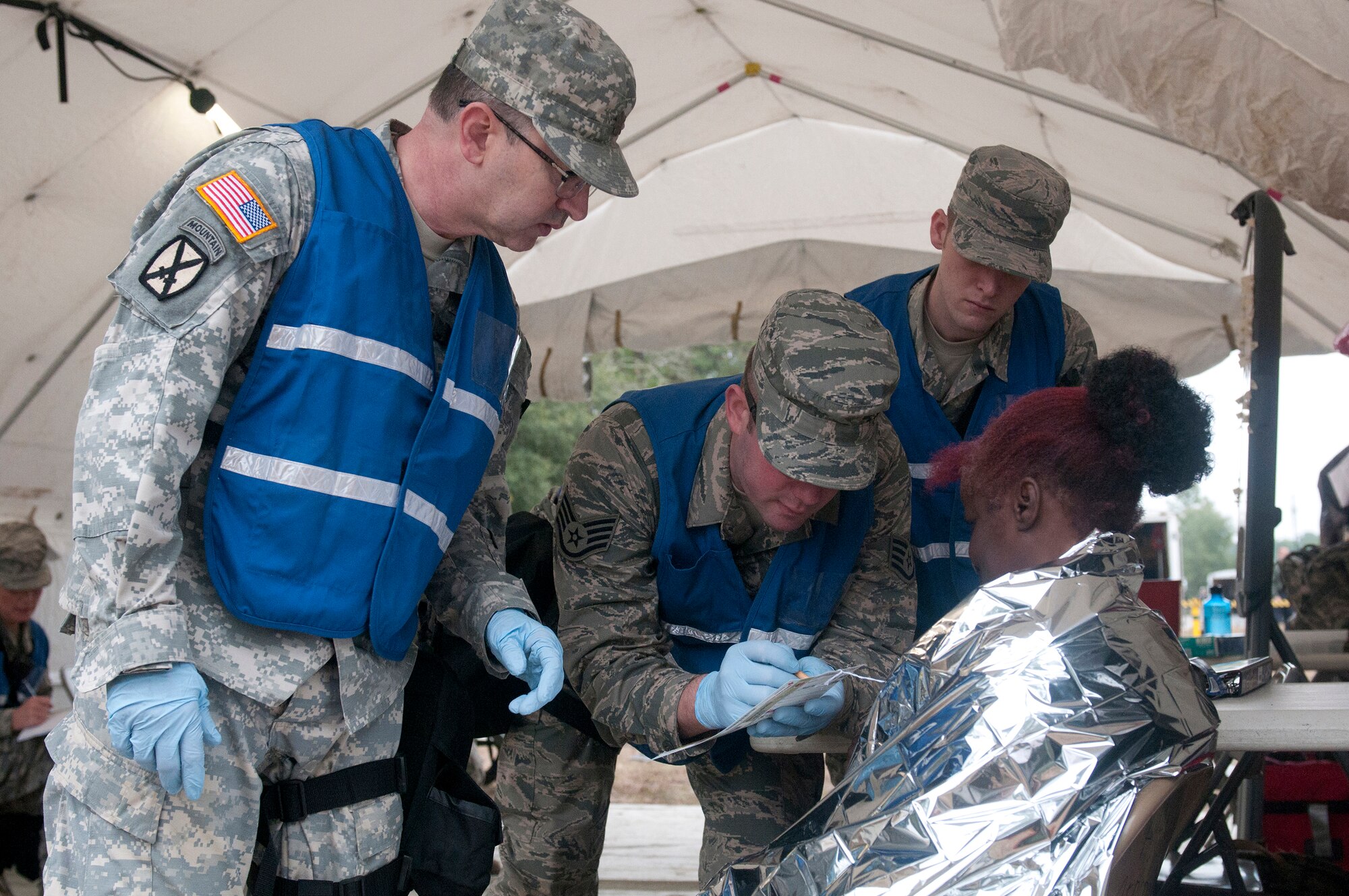 Soldiers and Airmen from the Kentucky National Guard CERFP work to triage a simulated patient during Operation Starke Thunder at Camp Blanding in Starke, Fla., Jan. 13, 2015. The four-day exercise certified the joint Kentucky Army and Air Guard emergency-response team as mission-ready. (U.S. Air National Guard photo by Staff Sgt. Vicky Spesard)