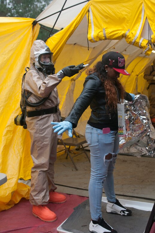 A soldier from the Kentucky National Guard CERFP checks a simulated patient for contamination as the patient is moved from the hot zone into the cold zone for further triage during Operation Starke Thunder at Camp Blanding in Starke, Fla., Jan. 14, 2015. The four-day exercise certified the joint Kentucky Army and Air Guard emergency-response group as mission-ready. (U.S. Air National Guard photo by Staff Sgt. Vicky Spesard)