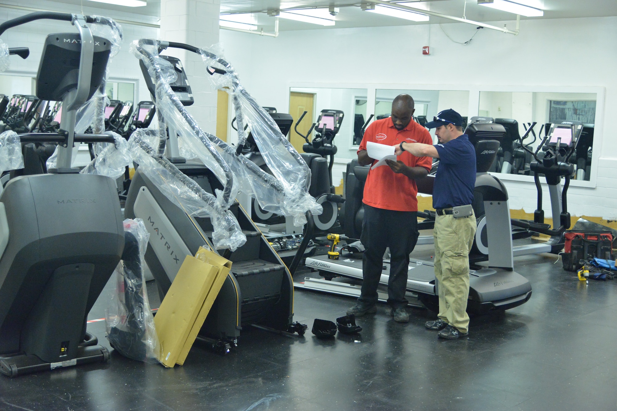 Fitness Center employee Rick Maris, right, talks with a vendor about new equipment. The center's new renovations include new equipment, flooring, electrical systems and more. (Photo by Todd Berenger)