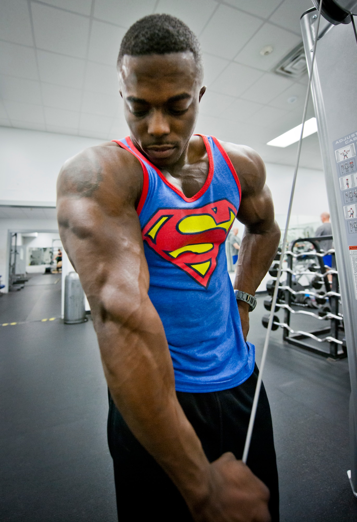 Senior Airman Terrence Ruffin, 16th Electronic Warfare Squadron, strains for an extra rep on a weight machine at the fitness center on Eglin Air Force Base, Fla.  In November, the Airman became the youngest professional bodybuilder on the circuit at age 21.  (U.S. Air Force photo/Samuel King Jr.)