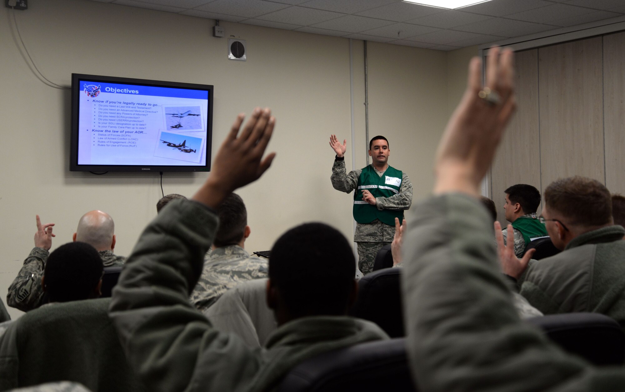 U.S. Air Force Capt. Christopher Bailey, 352nd Special Operations Group staff judge advocate from Abilene, Texas, asks deploying Airmen if they have taken care of legal matters prior to their deployment during a base exercise Jan. 27, 2015, on RAF Mildenhall, England. The purpose of this exercise is to test the abilities of Airmen to ensure they're mission ready in the event of a deployment. (U.S. Air Force photo by Senior Airman Christine Griffiths/Released)