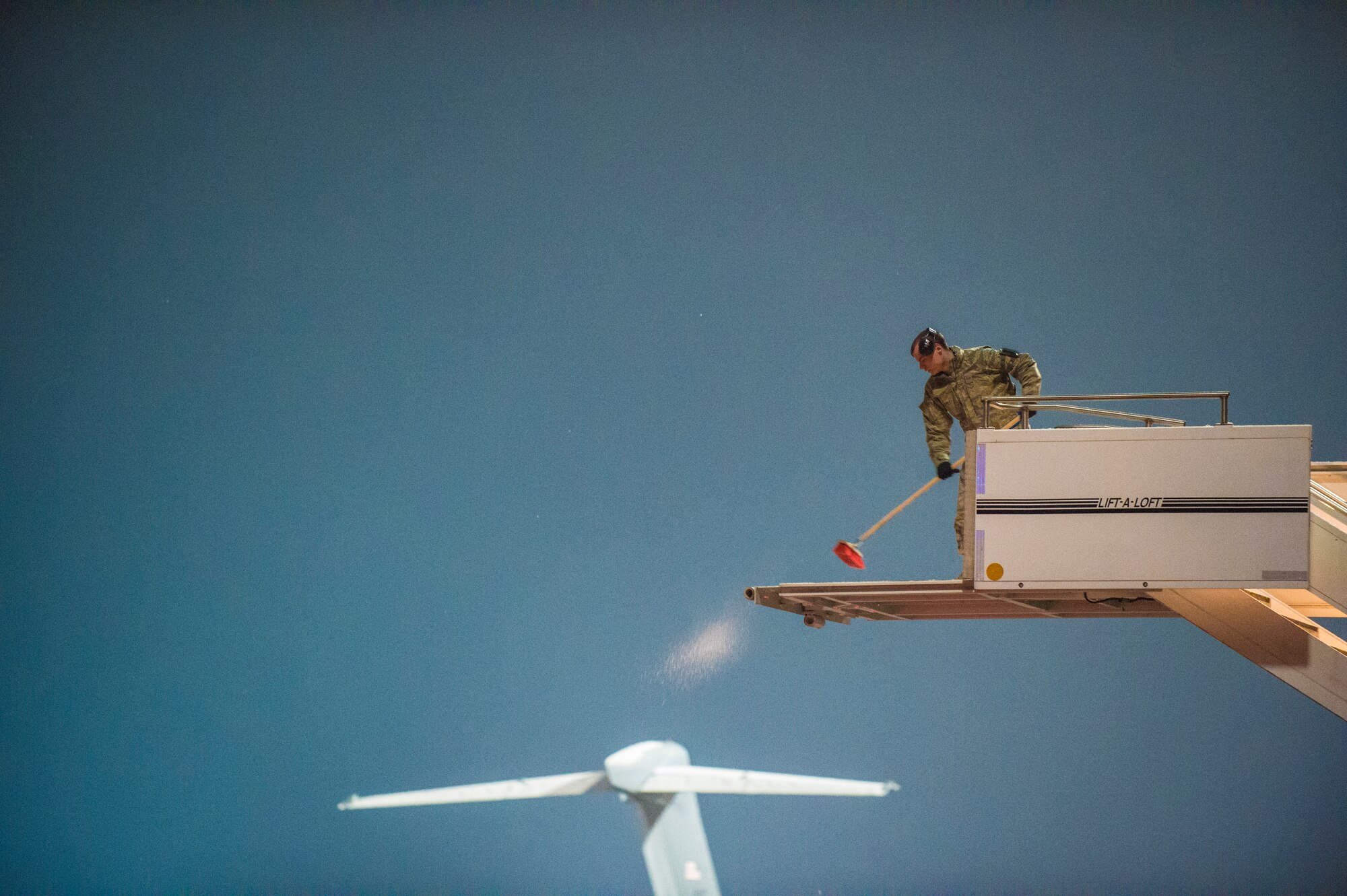 Airman 1st Class Robert Jarratt,721st Aerial Port Squadron fleet service specialist, sweeps snow off of a staircase before the arrival of The President of the United States on Ramstein Air Base, Germany, Jan. 27, 2015. Air Force One stopped by for a refueling on the way to and from Saudi Arabia.  (U.S. Air Force photo/Senior Airman Nicole Sikorski)