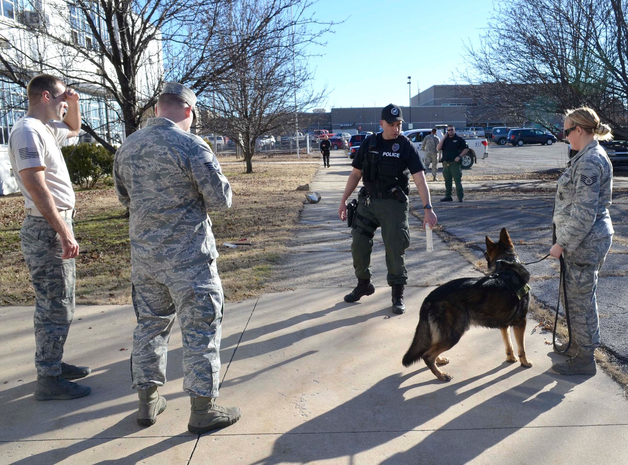 Sgt. Chad McCluskey, Augusta Department of Public Safety K-9 handler, demonstrates how he rewards his K-9 to members of the 22nd Security Forces Squadron, Jan. 27, 2015, in Independence, Kan. Civilian law enforcement agencies often utilize different tools and tactics than the security forces team. The training opportunity allowed various police agencies to work together and share techniques and ideas. (Courtesy photo)