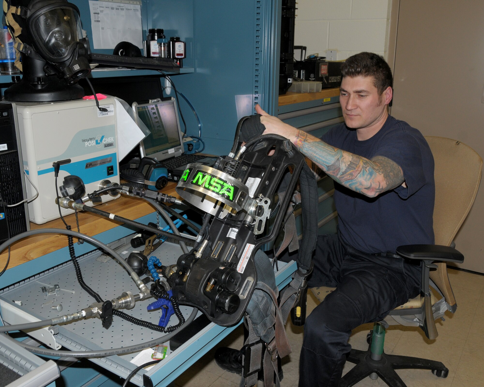Lt. Chris Baer, Niagara Falls Air Reserve Station Fire Department, driver operator performs flow testing on a self-contained breathing apparatus (SCBA) pack using the Posi-Track Three tester at the Niagara Falls Air Reserve Station on January 29, 2015. The SCBA is used by firefighters to help protect them from all inhalation hazards, i.e. smoke, hazmat, asbestos. The testing unit senses everything that is mechanical, electrical and electronic with the pack ensuring that everything is up to Occupational Safety & Health Administration (OSHA) standards including the correct amount of air pressure, the correct decibel that the alarm on the pack gives out. (U.S. Air Force Reserve photo by Peter Borys) 