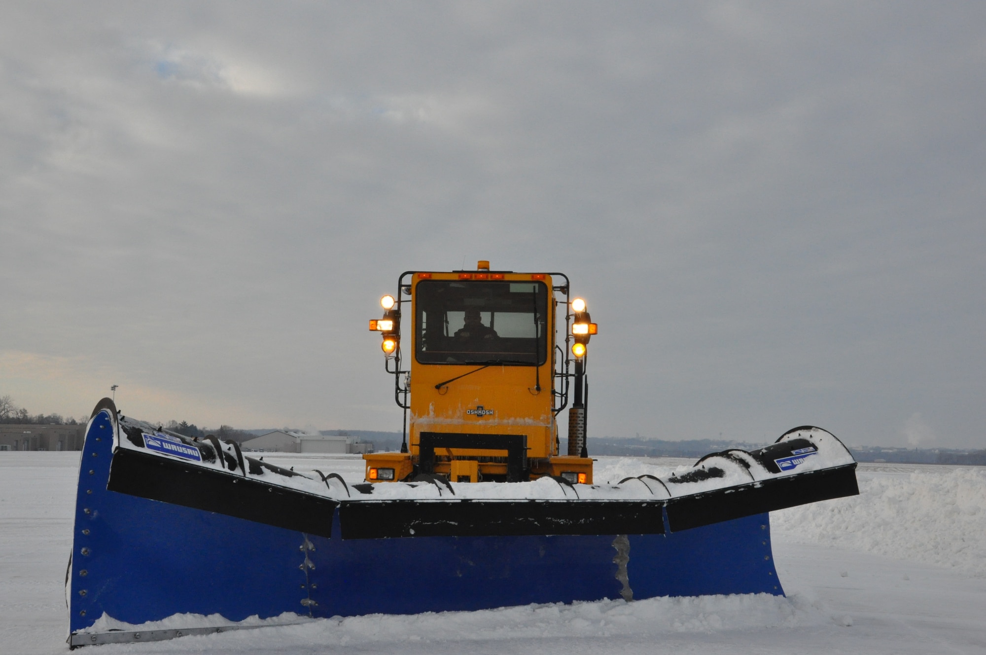 Derek Harlow plows the snow from the airfield for Base Operations. With blowing and drifting snow, the airfield may have to be cleaned several times throughout the day or night. (Air Force photo by Sandy Simison)