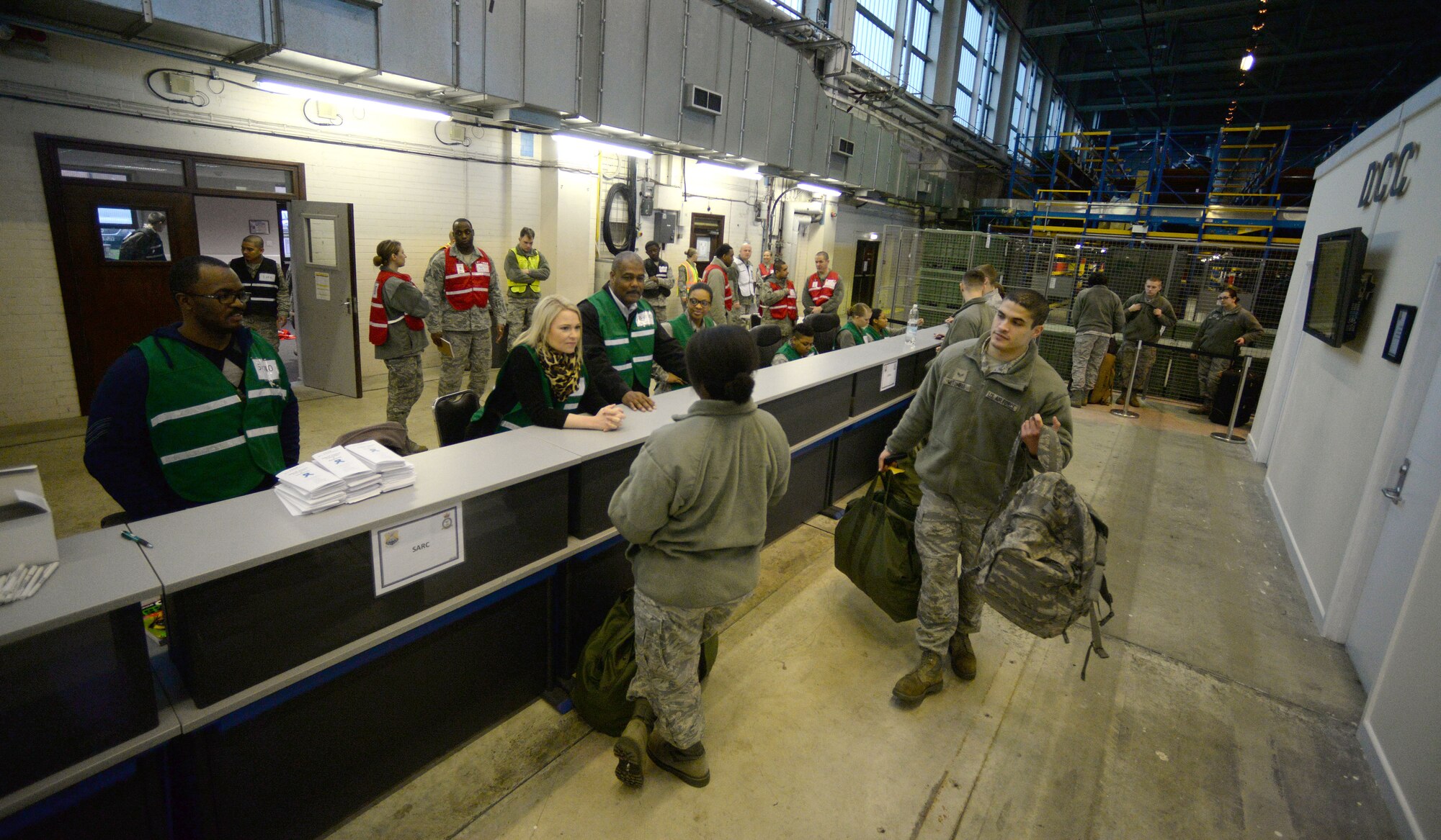 U.S. Air Force Airmen from RAF Mildenhall go through personnel deployment function line procedures during a base exercise Jan. 27, 2015, on RAF Mildenhall, England. The purpose of the PDF line is to test organizational and individual abilities to take care of personal issues prior to a deployment. (U.S. Air Force photo by Senior Airman Christine Griffiths/Released)