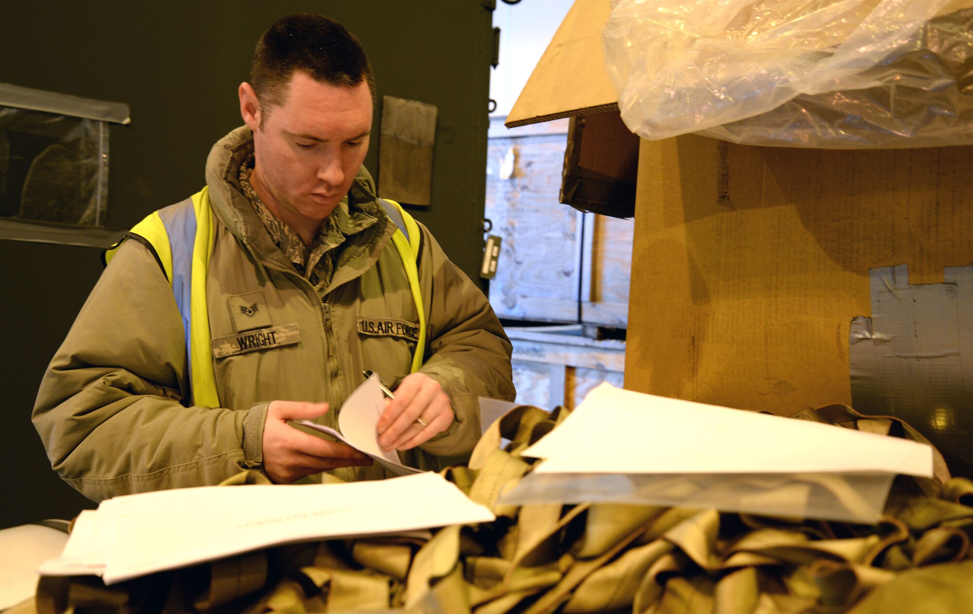U.S. Air Force Staff Sgt. Steven Wright, 100th Logistics Readiness Squadron NCO in charge of the augmentee program from Belton, S.C., inspects paperwork during a base exercise Jan. 27, 2015 on RAF Mildenhall, England. Wright inspects the paperwork to makes sure information is correct and identifies that there is no hazardous material listed that hasn’t been certified. (U.S. Air Force photo by Senior Airman Christine Griffiths/Released) 