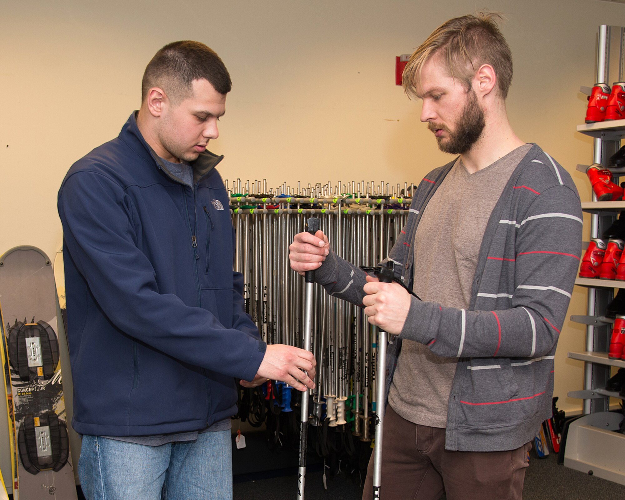 Chris Cerovac (left), an Outdoor Recreation specialist, explains to Brent Housley the best way to choose equipment for cross country and snowshoeing at Outdoor Recreation, Jan 23. Outdoor Recreation is now offering ski, snowboard and other winter equipment to rent. Fittings, tuning and wax services for skis and snowboards are also available. (U.S. Air Force photo by Mark Herlihy)
