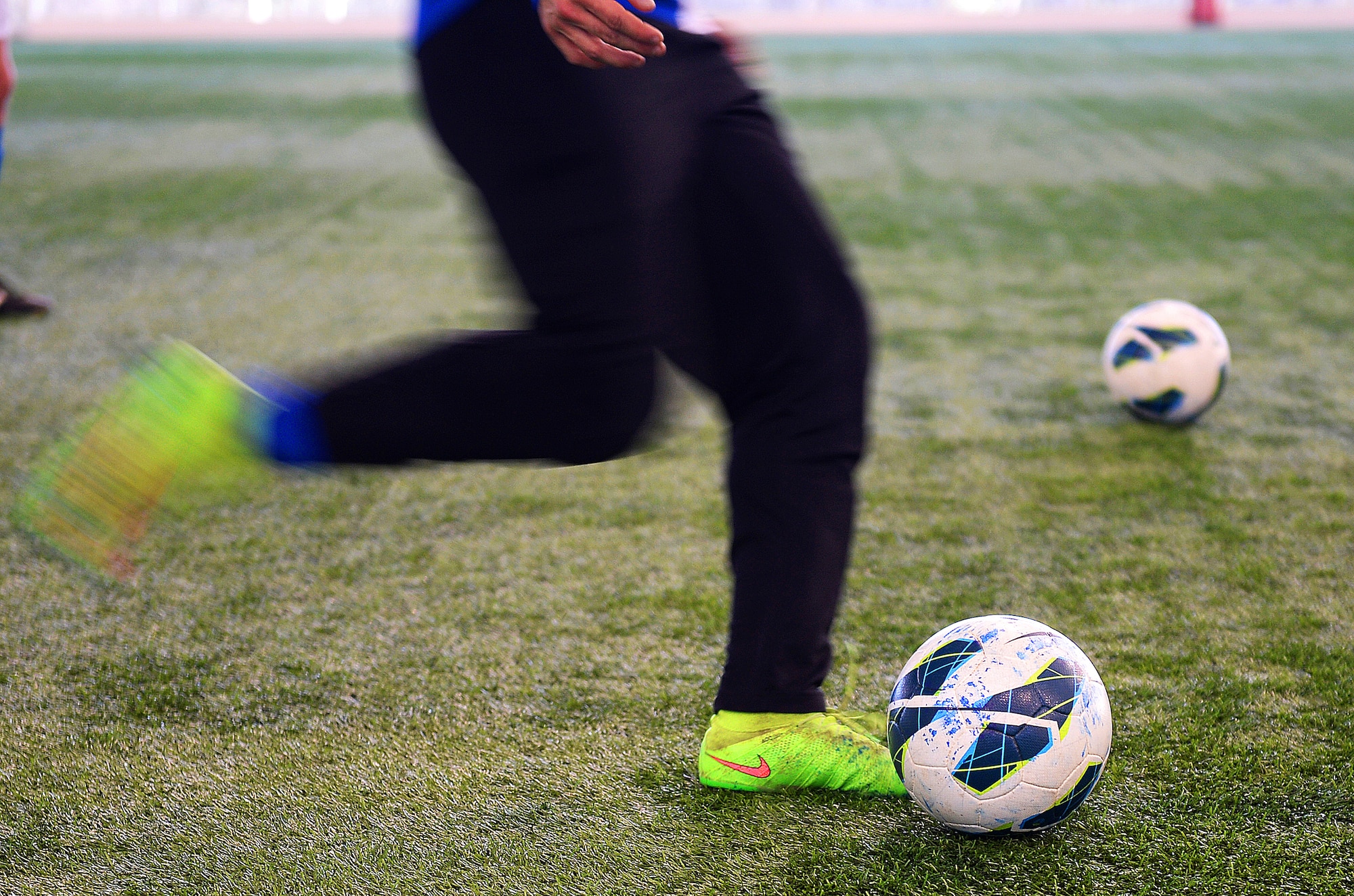 Senior Airman Mathew Guajardo, a forward for the Liberty Football Club, prepares to pass the ball to a teammate during a warm-up session before a match against the world-ranked England Cerebral Palsy team at St. George’s Park, England, Jan. 25, 2015. The England CP team ended their four-day training camp with a friendly competitive match against the American team. (U.S. Air Force photo by Staff Sgt. Emerson Nuñez/Released)