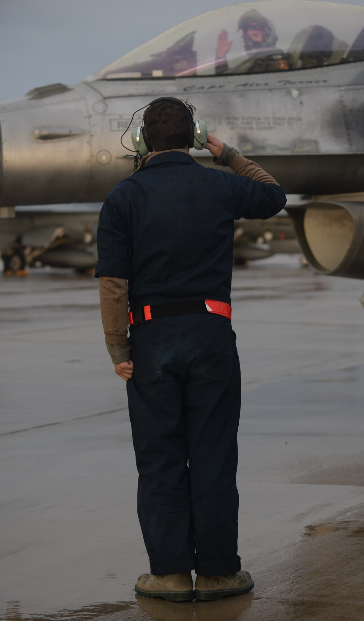 U.S. Air Force Airman 1st Class Glenn Wootres, a dedicated crew chief assigned to the 52nd Expeditionary Aircraft Maintenance Squadron, salutes a pilot taxiing an F-16 Fighting Falcon fighter aircraft during a flying training deployment on the flightline at Souda Bay, Greece, Jan. 29, 2015. Eighteen F-16s from the 52nd Fighter Wing at Spangdahlem Air Base, Germany, participated in the flying training deployment at Souda Bay Jan. 16-Feb. 13, 2015, between the Greek and U.S. Air Forces. (U.S. Air Force photo by Staff Sgt. Joe W. McFadden/Released)