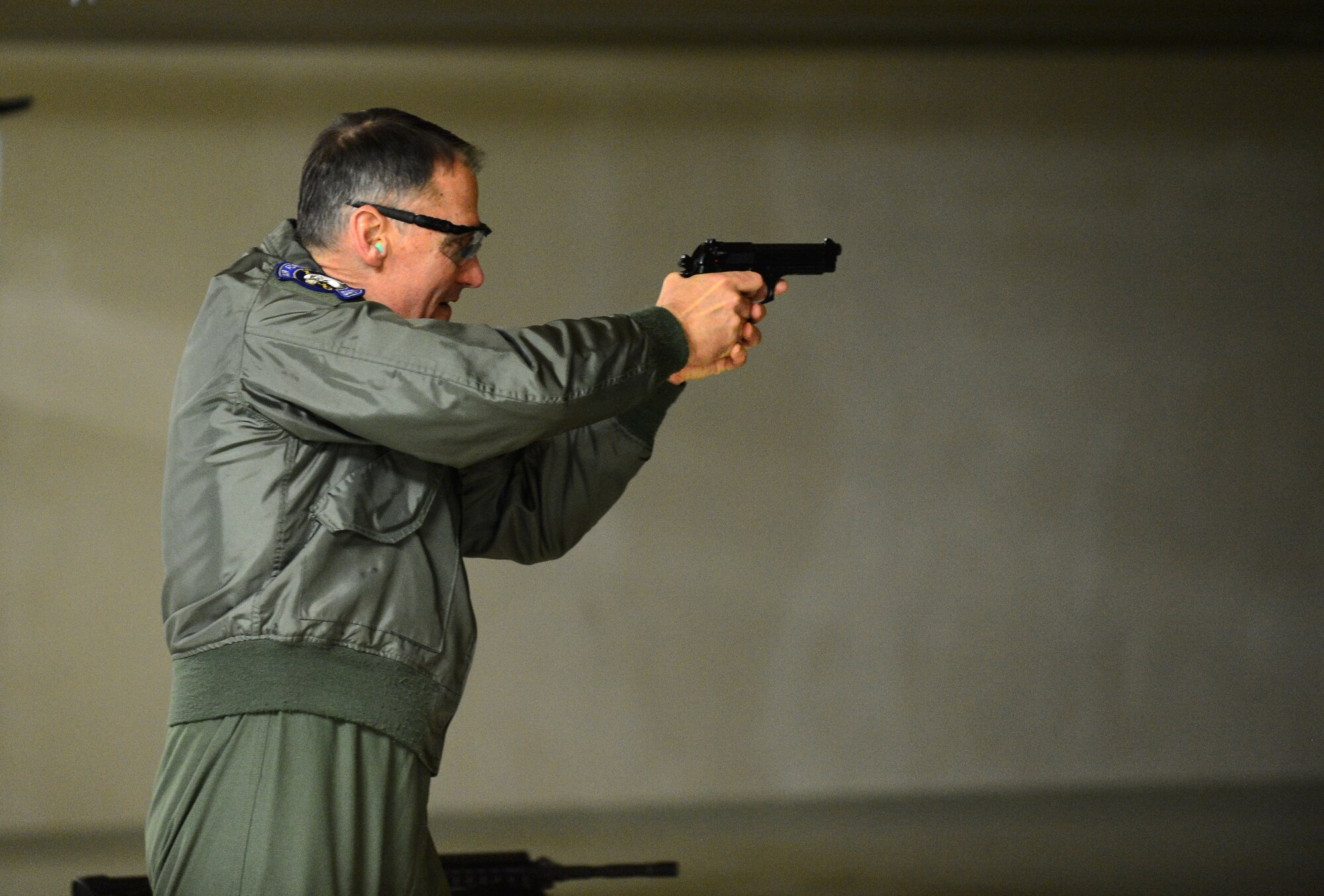U.S. Air Force Maj. Gen. Kurt Neubauer, Air Force Chief of Safety, aims an M9 Beretta pistol during a visit to the shooting range at Spangdahlem, Air Base, Germany, Jan. 23, 2015. Neubauer also tested out the Saber Driving Course during his visit to understand how Spangdahlem Airmen train to handle bad driving conditions. (U.S. Air Force photo by Airman 1st Class Luke Kitterman/Released)
