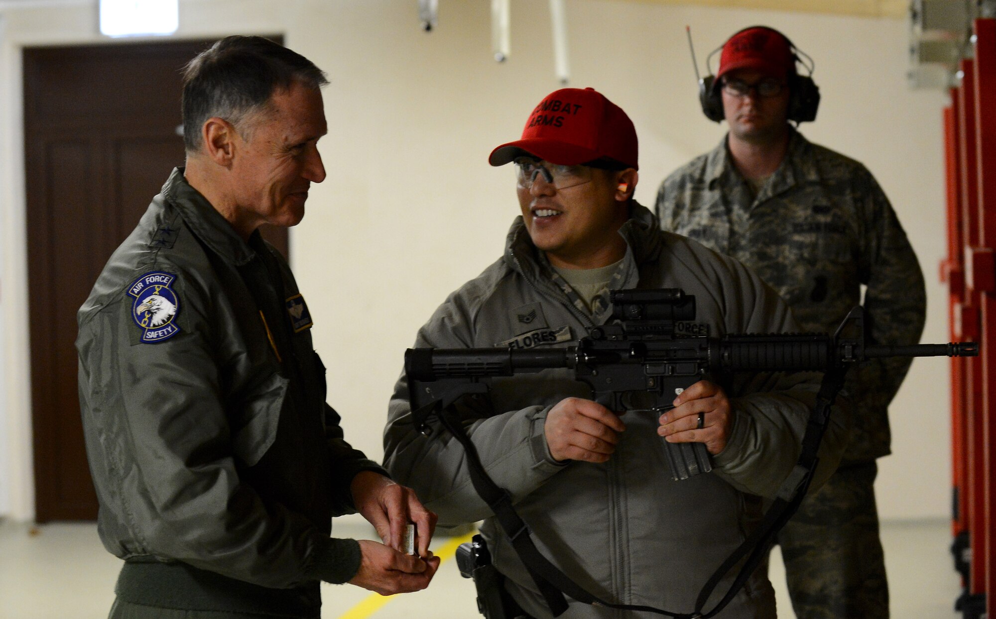 U.S. Air Force Maj. Gen. Kurt Neubauer, Air Force Chief of Safety, listens to U.S. Air Force Staff Sgt. Joseph Florez, 52nd Security Forces Squadron combat arms trainer, before going through the safety procedures of using an M-4 rifle at the shooting range on Spangdahlem Air Base, Germany, Jan. 23, 2015. Neubauer fired an M-4 rifle and an M9 Beretta pistol toward targets at different distances. (U.S. Air Force photo by Airman 1st Class Luke Kitterman/Released)