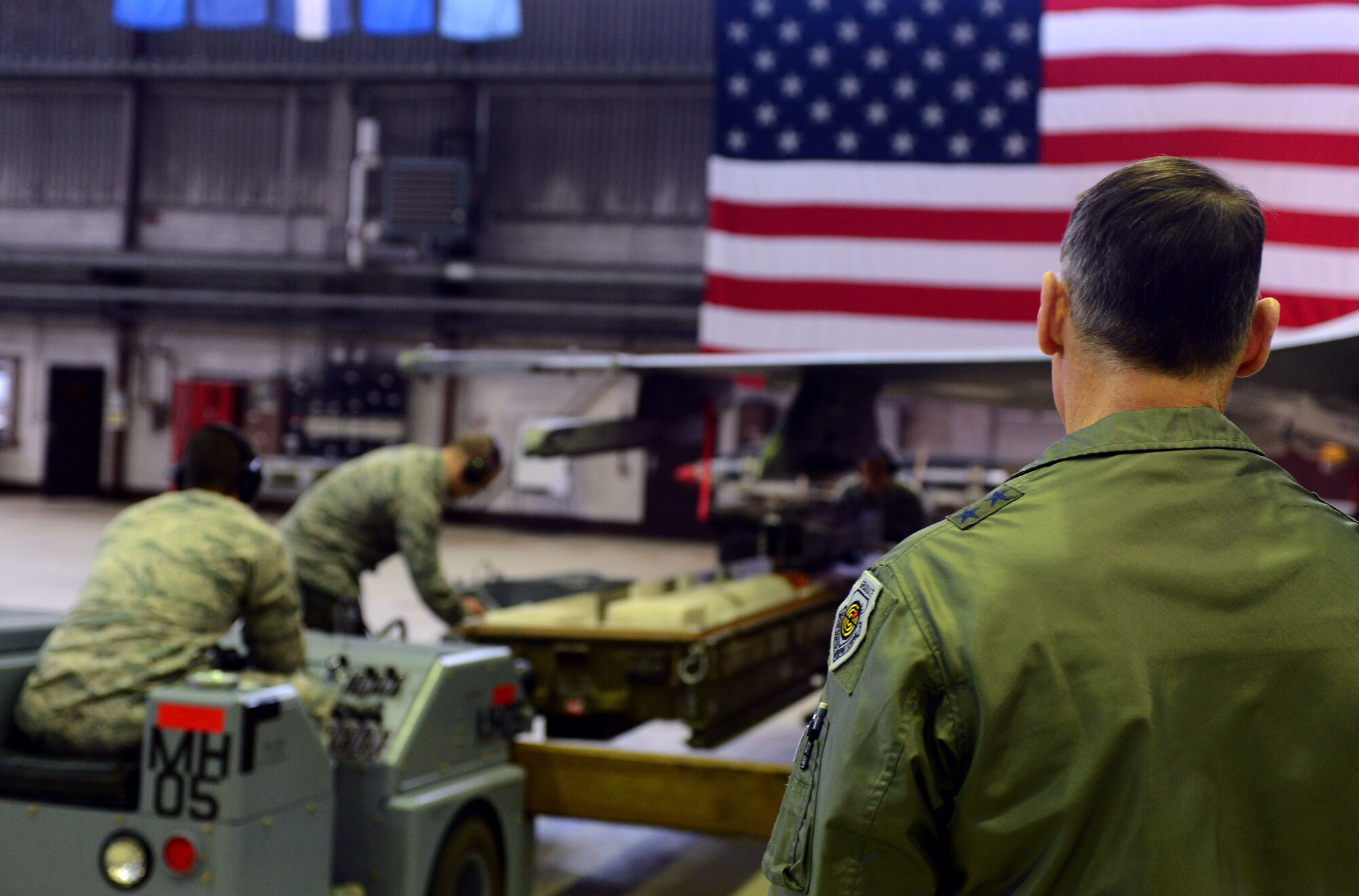 U.S. Air Force Maj. Gen. Kurt Neubauer, Air Force Chief of Safety, views a demonstration of a weapons load in Hangar 1 at Spangdahlem Air Base, Germany, Jan. 23, 2015. Supervisors evaluate weapon loaders every month on their accuracy and time. (U.S. Air Force photo by Airman 1st Class Luke Kitterman/Released)
