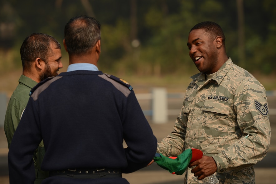 U.S. Air Force Staff Sgt. Justin Price speaks with Bangladesh Air Force maintenance counterparts during Exercise Cope South at BAF Base Bangabandhu, Jan. 27, 2015. Price is a repair and reclamation specialist assigned to the 374th Maintenance Squadron, Yokota Air Base, Japan. Cope South helps cultivate common bonds, foster good will, and improve readiness and compatibility between members of the Bangladesh and U.S. Air Forces. (U.S. Air Force photo by 1st Lt. Jake Bailey/Released)