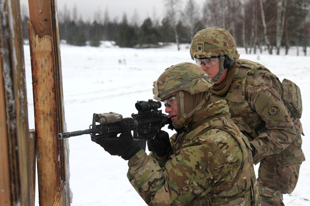 U.S. Army Sgt. Mitchell, right, observes and trains another soldier firing his weapon at targets while participating in a live-fire range during exercise Operation Atlantic Resolve in Aazi, Latvia, Jan. 23, 2015. Mitchell is assigned to the 2nd Cavalry Regiment. 
