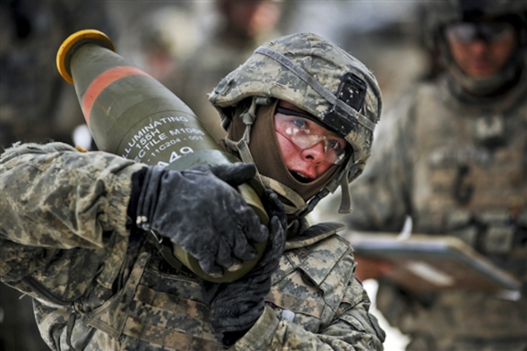 U.S. Army Pvt. John Underhill carries 155-mm artillery rounds to prepare for a mass fire mission during Operation Chosin, a training exercise, at the 7th Army Joint Multinational Training Command’s Grafenwoehr Training Area, Germany, Jan. 27, 2015. Underhill is assigned to Field Artillery Squadron, 2nd Cavalry Regiment.  


 