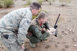 150130-Z-VA676-278 – Two Michigan Air National Guard Airmen practice using a rescue radio during a combat search and rescue exercise in the Barry M. Goldwater Air Force Range, west of Tucson, Ariz., Jan. 30, 2015. The 107th Fighter Squadron and related elements of the 127th Wing are participating in a series of training exercises known as Snowbird, while at the Total Force Training Center at Davis-Monthan Air Force Base. The 107th flies the A-10 Thunderbolt II and is assigned to Selfridge Air National Guard Base, Mich. (U.S. Air National Guard photo by Tech. Sgt. Dan Heaton)