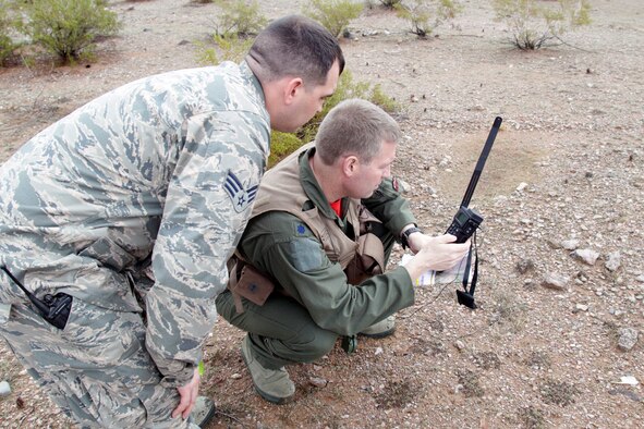 150130-Z-VA676-278 – Two Michigan Air National Guard Airmen practice using a rescue radio during a combat search and rescue exercise in the Barry M. Goldwater Air Force Range, west of Tucson, Ariz., Jan. 30, 2015. The 107th Fighter Squadron and related elements of the 127th Wing are participating in a series of training exercises known as Snowbird, while at the Total Force Training Center at Davis-Monthan Air Force Base. The 107th flies the A-10 Thunderbolt II and is assigned to Selfridge Air National Guard Base, Mich. (U.S. Air National Guard photo by Tech. Sgt. Dan Heaton)