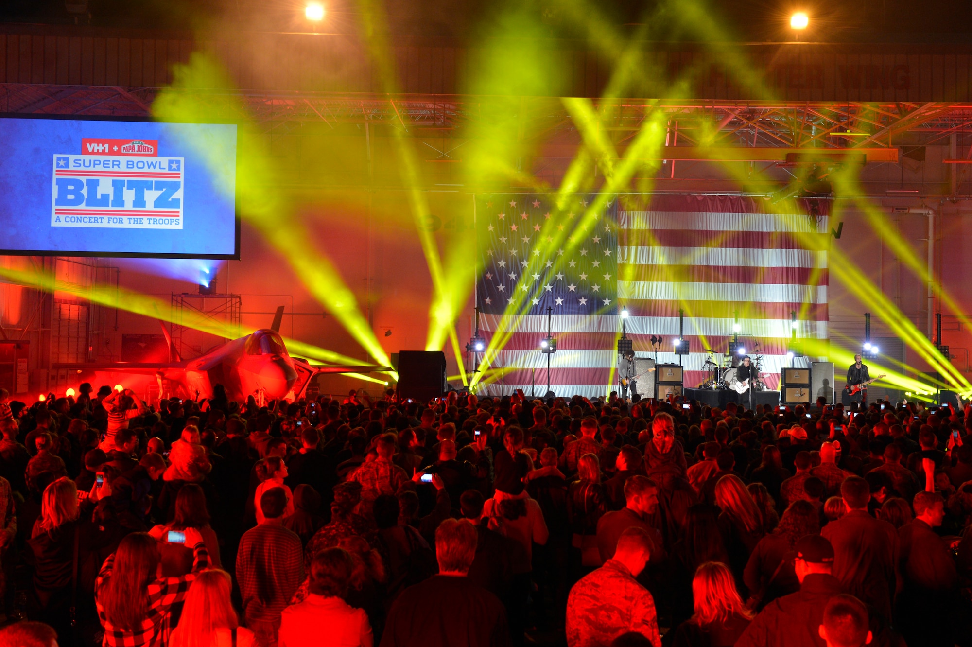 Airmen gather around the stage to watch Fall Out Boy for the VH1 Super Bowl Blitz concert at Luke Air Force Base, Arizona, Jan. 30, 2015. The event was hosted by Nick Lachey in Hangar 999 at Luke. (U.S. Air Force photo by Airman Pedro Mota)