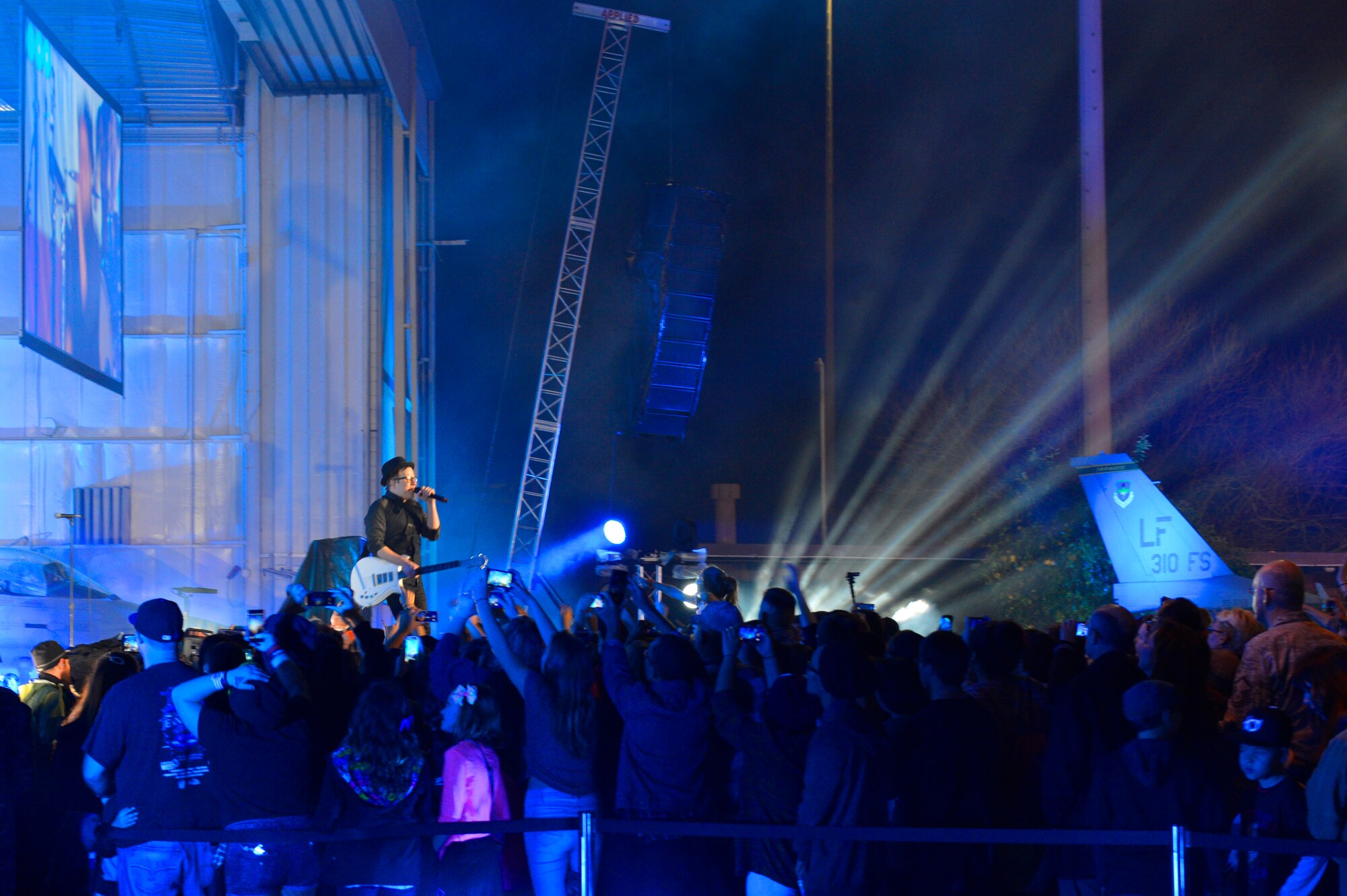 Airmen gather around the stage to watch Fall Out Boy for the VH1 Super Bowl Blitz concert at Luke Air Force Base, Arizona, Jan. 30, 2015. The concert for the troops event was hosted by Nick Lachey in Hangar 999 at Luke. (U.S. Air Force photo by Airman Pedro Mota)