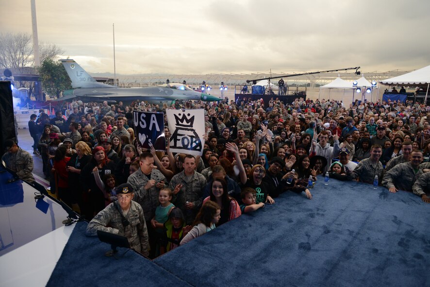 Airmen gather around the stage awaiting the arrival of Fall Out Boy and Charli XCX for the VH1 concert at Luke Air Force Base, Arizona, Jan. 30, 2015. The concert for the troops event was hosted by Nick Lachey in Hangar 999 at Luke.  (U.S. Air Force photo by Senior Airman James Hensley)