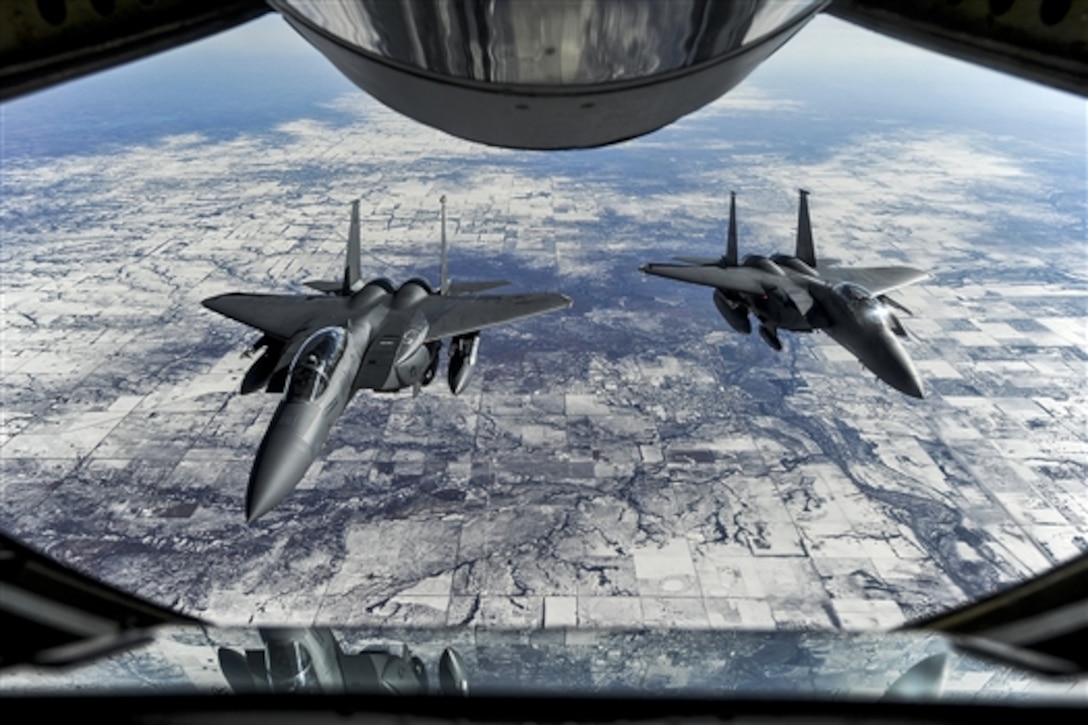 U.S. Air Force F-15E Strike Eagles wait to receive fuel from a KC-135R Stratotanker during exercise Red Flag 15-1 on their way to Nellis Air Force Base, Nev., Jan. 23, 2015. The F-15 crews are assigned to the 4th Fighter Wing. Red Flag provides a series of intense air-to-air scenarios for aircrew and ground personnel to increase their combat readiness and effectiveness for real-world operations.