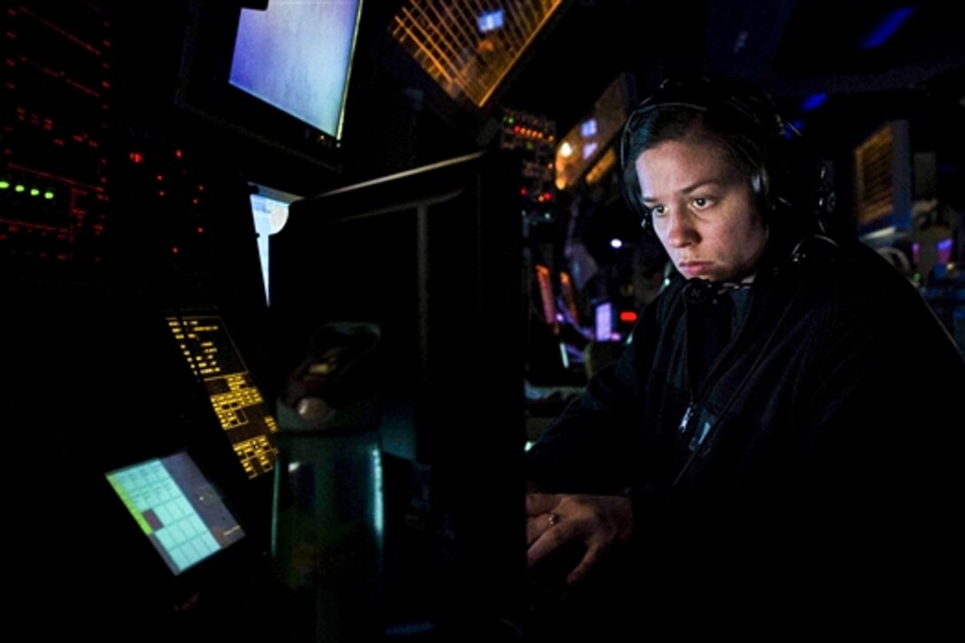 Navy Lt. j.g. Lisa Schmidt stands watch in the combat information center aboard the guided missile destroyer USS Forrest Sherman in the Atlantic Ocean, Jan. 22, 2015. The destroyer is training with the Theodore Roosevelt Carrier Strike Group to prepare for deployment. 