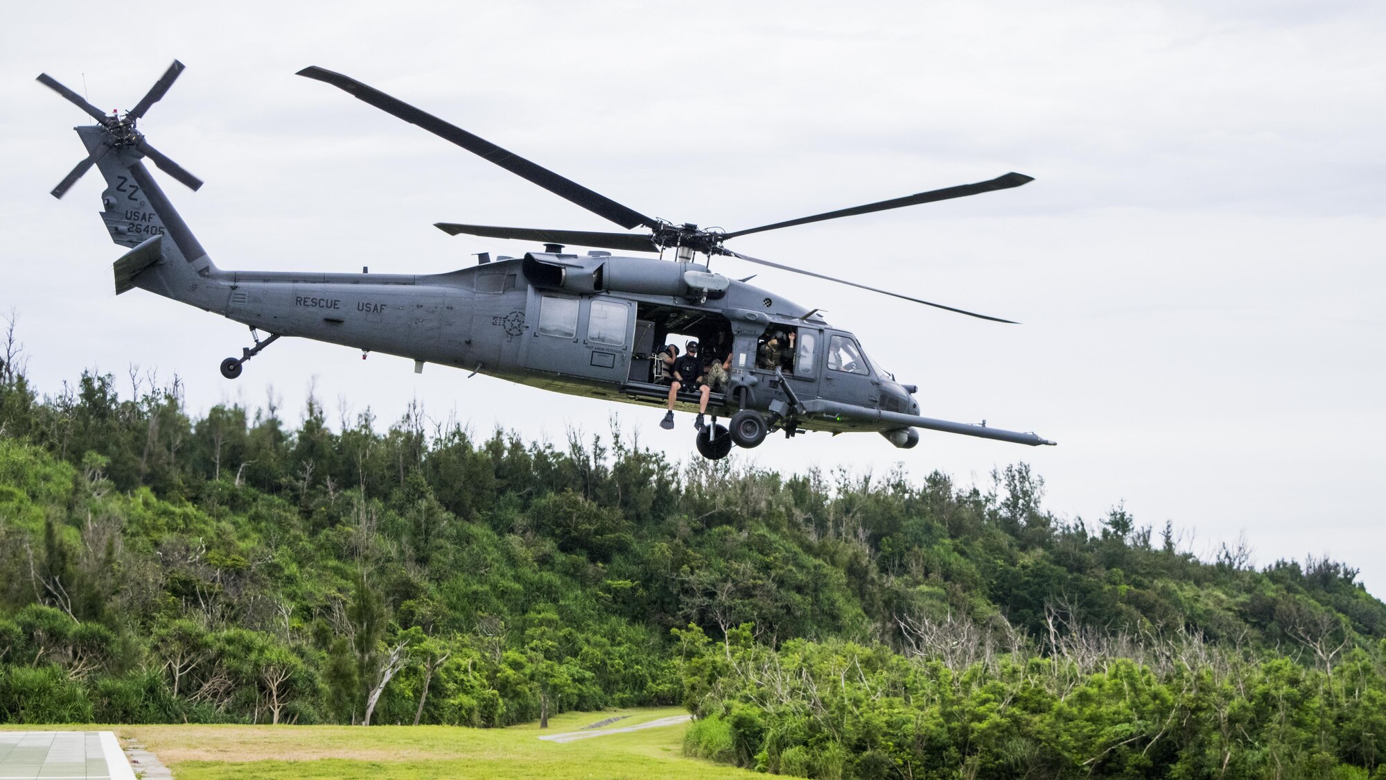 A Kadena-based HH-60 from the 33rd Rescue Squadron leaves to conduct training with the 320th Special Tactics Squadrons’ Gold Team during Gold Thunder 2.0 held at Camp Hansen July 24, 2015.  A 320th Special Tactics Squadron pararescueman hoists a Gold Team member out of the water into a Kadena-based HH-60 from the 33rd Rescue Squadron during Gold Thunder 2.0 held at Camp Hansen July 24, 2015.  The exercise scenario ended with a sanitation and evacuation of the forward operating location by water via rotary wing aircraft.  Gold Thunder 2.0 is a humanitarian assistance disaster/relief scenario exercise put together to train the combat mission support personnel in land and water navigation, establishing a special tactics operations center and a forward operating logistics hub along with other skills such as all-terrain vehicle qualification training, Krav Maga training and exfiltration capabilities with rotary wing aircraft. (Photo courtesy of Staff Sgt. Matthew Sharp)