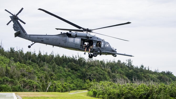 A Kadena-based HH-60 from the 33rd Rescue Squadron leaves to conduct training with the 320th Special Tactics Squadrons’ Gold Team during Gold Thunder 2.0 held at Camp Hansen July 24, 2015.  A 320th Special Tactics Squadron pararescueman hoists a Gold Team member out of the water into a Kadena-based HH-60 from the 33rd Rescue Squadron during Gold Thunder 2.0 held at Camp Hansen July 24, 2015.  The exercise scenario ended with a sanitation and evacuation of the forward operating location by water via rotary wing aircraft.  Gold Thunder 2.0 is a humanitarian assistance disaster/relief scenario exercise put together to train the combat mission support personnel in land and water navigation, establishing a special tactics operations center and a forward operating logistics hub along with other skills such as all-terrain vehicle qualification training, Krav Maga training and exfiltration capabilities with rotary wing aircraft. (Photo courtesy of Staff Sgt. Matthew Sharp)