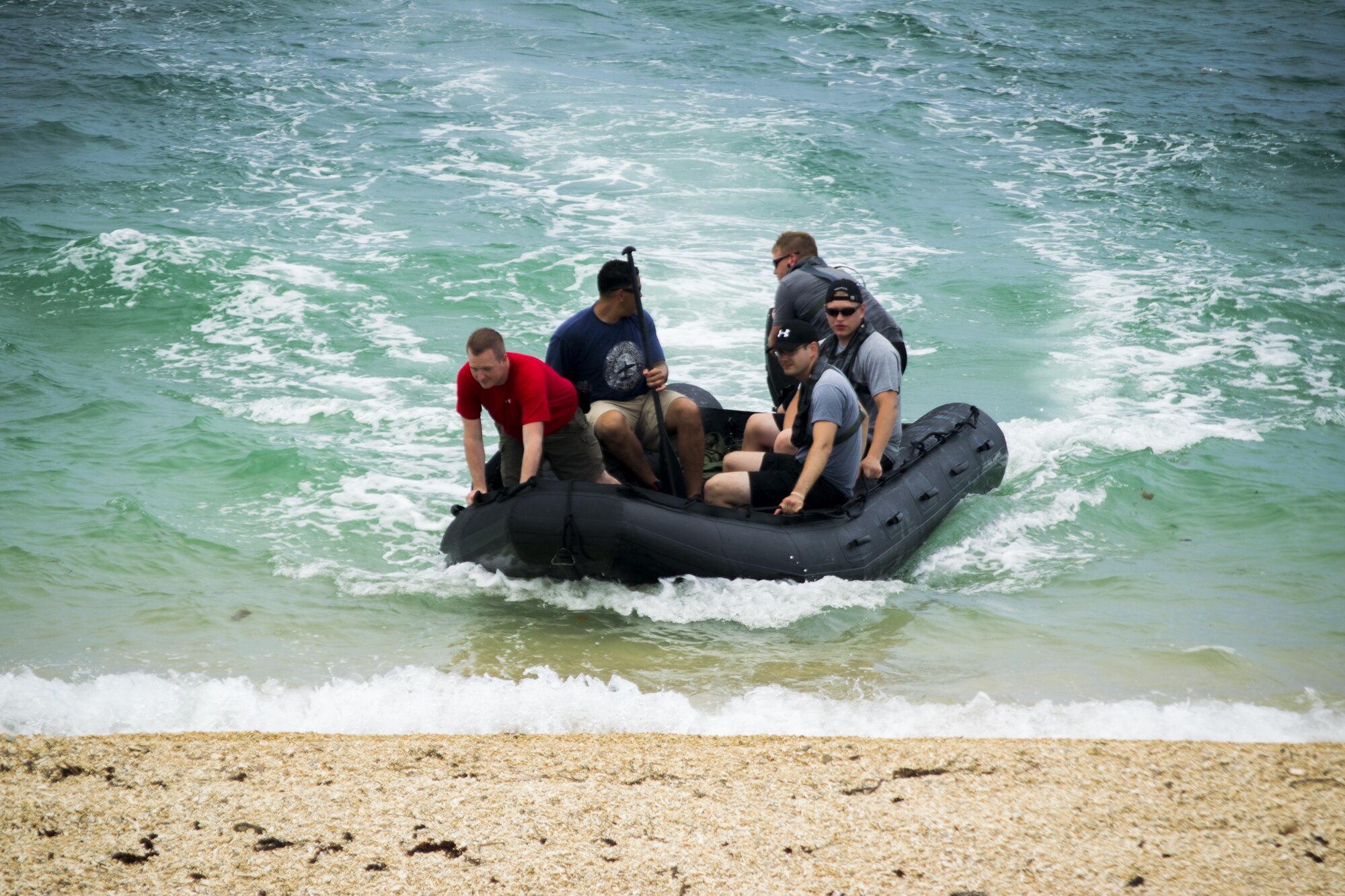 The second team from Gold Thunder 2.0 arrives at their forward operating location on Camp Hansen, Japan, June 23, 2015 during the water navigation portion of the exercise.  Gold Thunder 2.0 is a humanitarian assistance disaster relief scenario exercise put together to train the combat mission support personnel in land and water navigation, establishing a special tactics operations center and a forward operating supply point along with other skills such as quad qualification training, Krav Maga training and exfiltration capabilities with rotary wing aircraft.  (Photo courtesy of Staff Sgt. Matthew Sharp)