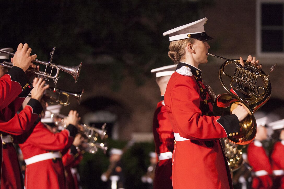U.S. Marines with the Marine Corps Drum and Bugle Corps perform during an evening parade at Marine Barracks Washington, D.C., May 29, 2015. The Evening Parade summer tradition began in 1934 and features the Silent Drill Platoon, the U.S. Marine Band, and the U.S. Marine Drum and Bugle Corps, and two marching companies. More than 3,500 guests attend the parade every week. (U.S. Marine Corps photo by Lance Cpl. Kayla V. McTaw/Released)