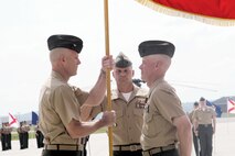 Col. Brian H. Bufton and Colonel Kevin H. Wild on the Quantico Marine Corps Air Facility flight line on June 26. Wild is passing the flag over to Bufton to signify the passing of commanding officer duties. The change of command ceremony was held on Friday and approximately 300 people were in attendance.