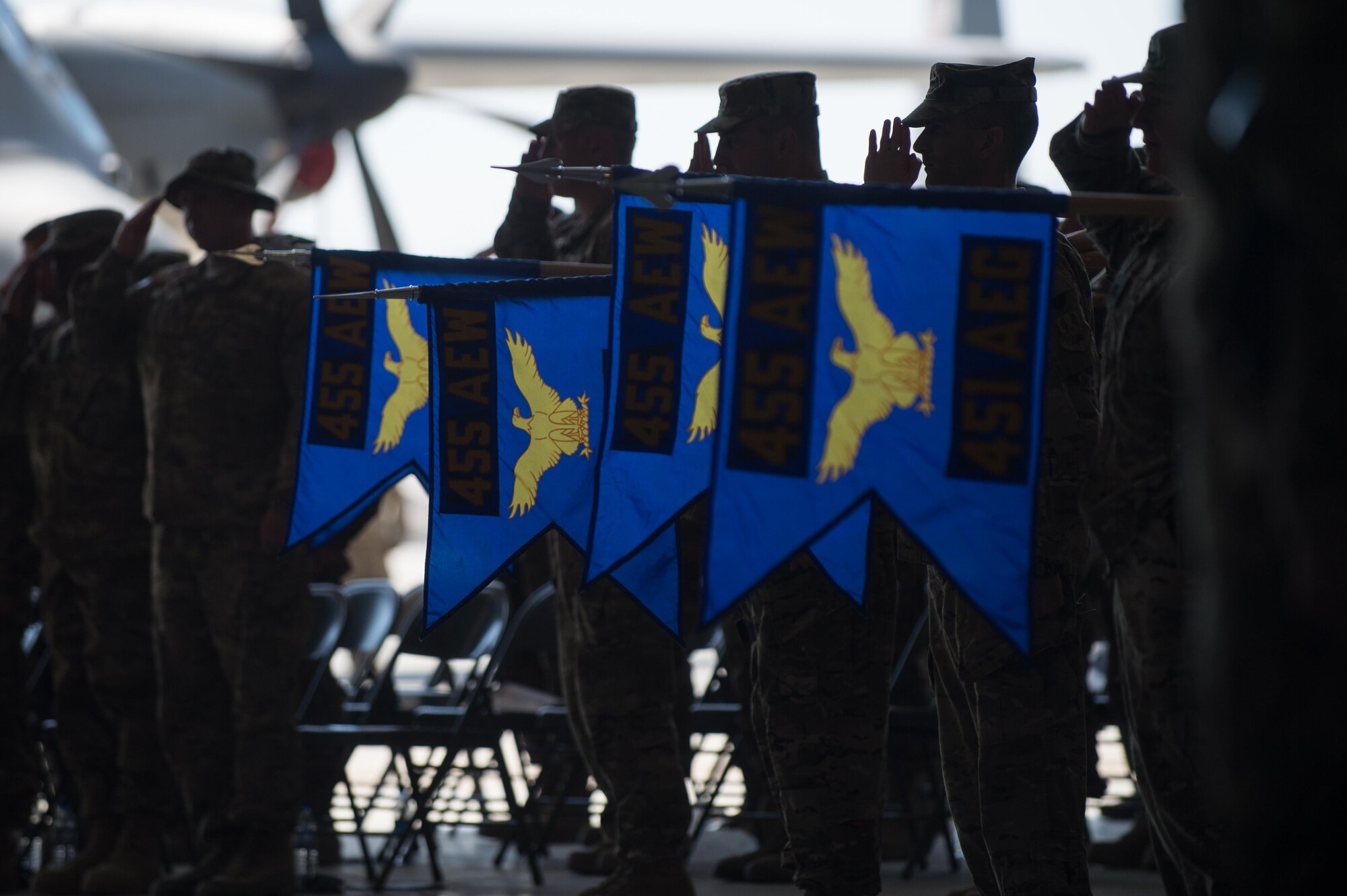 U.S. Airmen assigned to the 455th Air Expeditionary Wing lower the group guidons during the national anthem at the 455th AEW change of command ceremony at Bagram Airfield, Afghanistan, July 1, 2015. During the ceremony Kelly relinquished command of the 455th AEW to Brig. Gen. Dave Julazadeh.  (U.S. Air Force photo by Tech. Sgt. Joseph Swafford/Released)