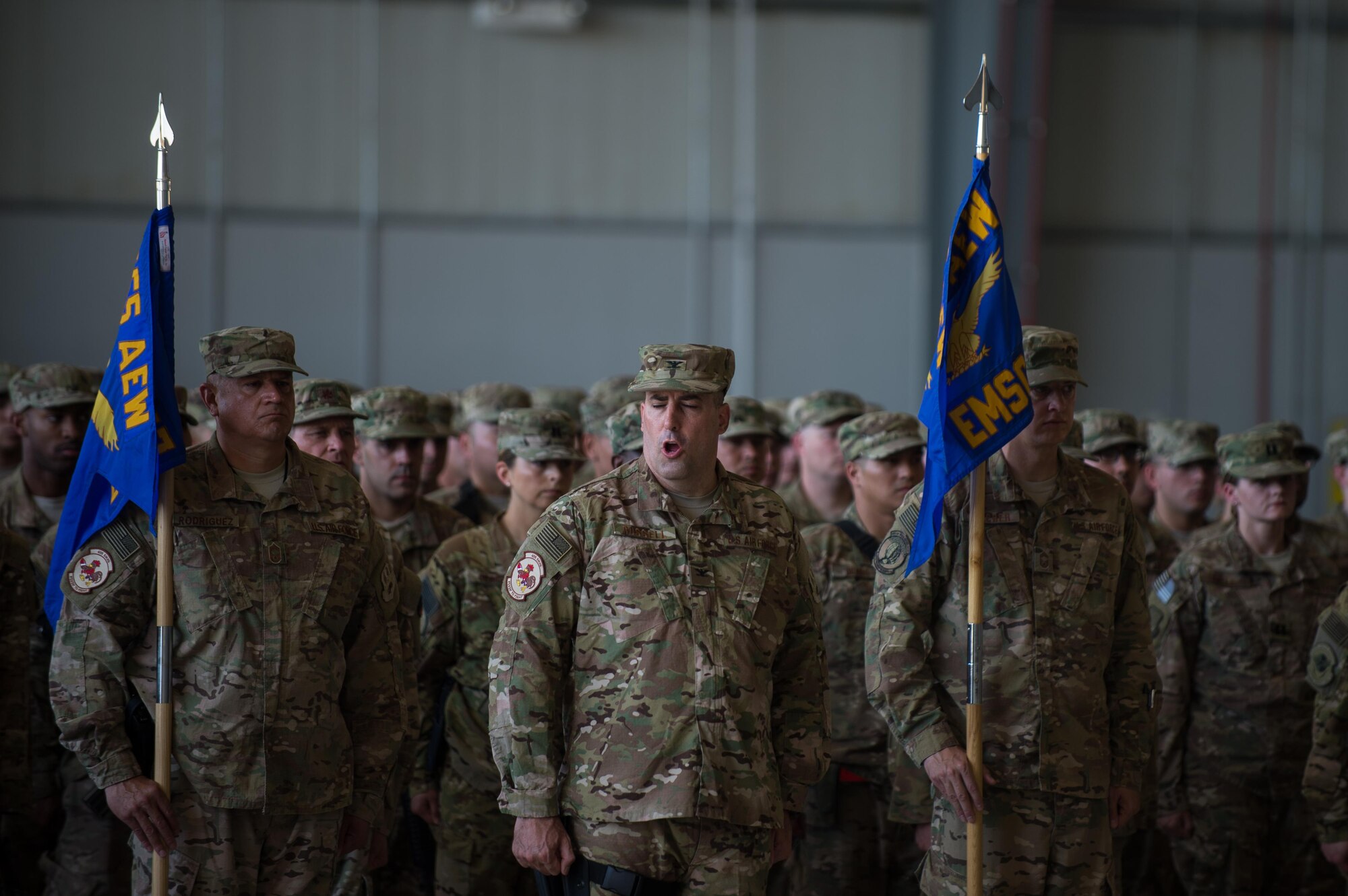 U.S. Air Force Col. Jeffrey Russell, 455th Expeditionary Maintenance Group commander, gives a command to 455th EMXG Airmen during the 455th Air Expeditionary Wing change of command ceremony July 1, 2015, at Bagram Airfield, Afghanistan. During the ceremony Brig. Gen. Dave Julazadeh took over command of the 455th AEW from Brig. Gen. Mark Kelly.  (U.S. Air Force photo by Tech. Sgt. Joseph Swafford/Released)