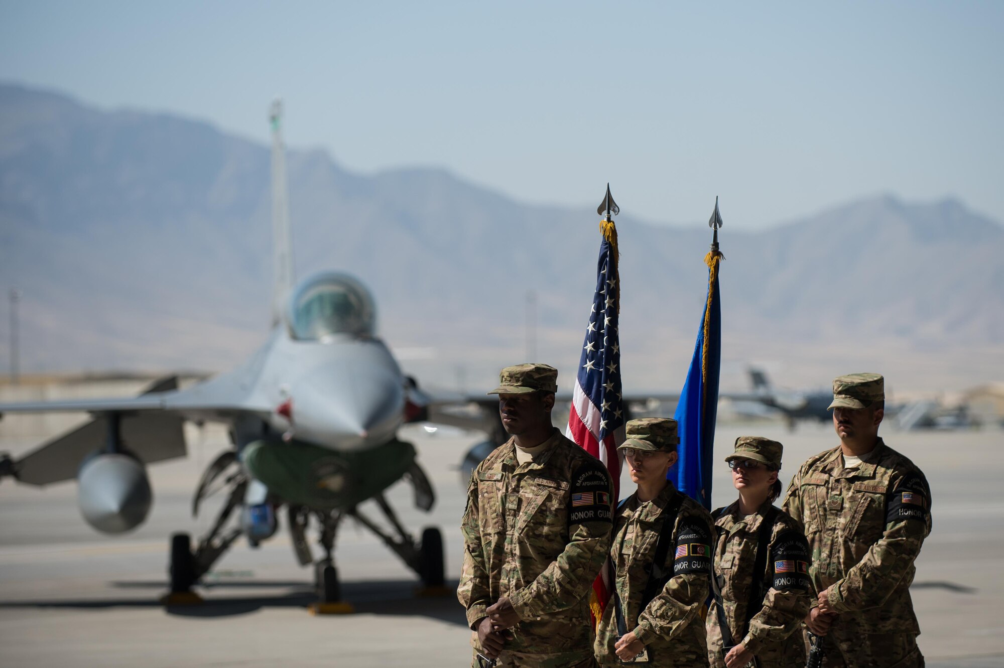 U.S. Airmen with the Bagram Airfield Honor Guard stand ready to present the colors during the 455th Air Expeditionary Wing change of command ceremony at Bagram Airfield, Afghanistan, July 1, 2015. During the ceremony Kelly relinquished command of the 455th AEW to Brig. Gen. Dave Julazadeh.  (U.S. Air Force photo by Tech. Sgt. Joseph Swafford/Released)