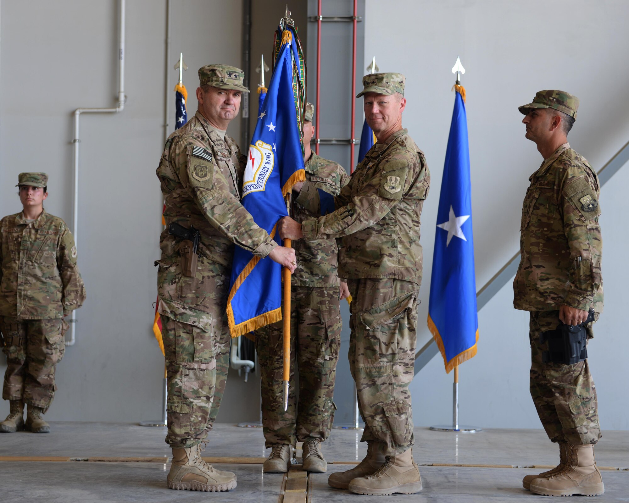 U.S. Air Force Maj. Gen. Scott West, 9th Air and Space Expeditionary Task Force-Afghanistan commander, relieves Brig. Gen. Mark Kelly from command during a change of command ceremony July 1, 2015, at Bagram Airfield, Afghanistan. Kelly relinquished command to the new commander Brig. Gen. Dave Julazadeh. (U.S. Air Force photo by Senior Airman Cierra Presentado/Released)  